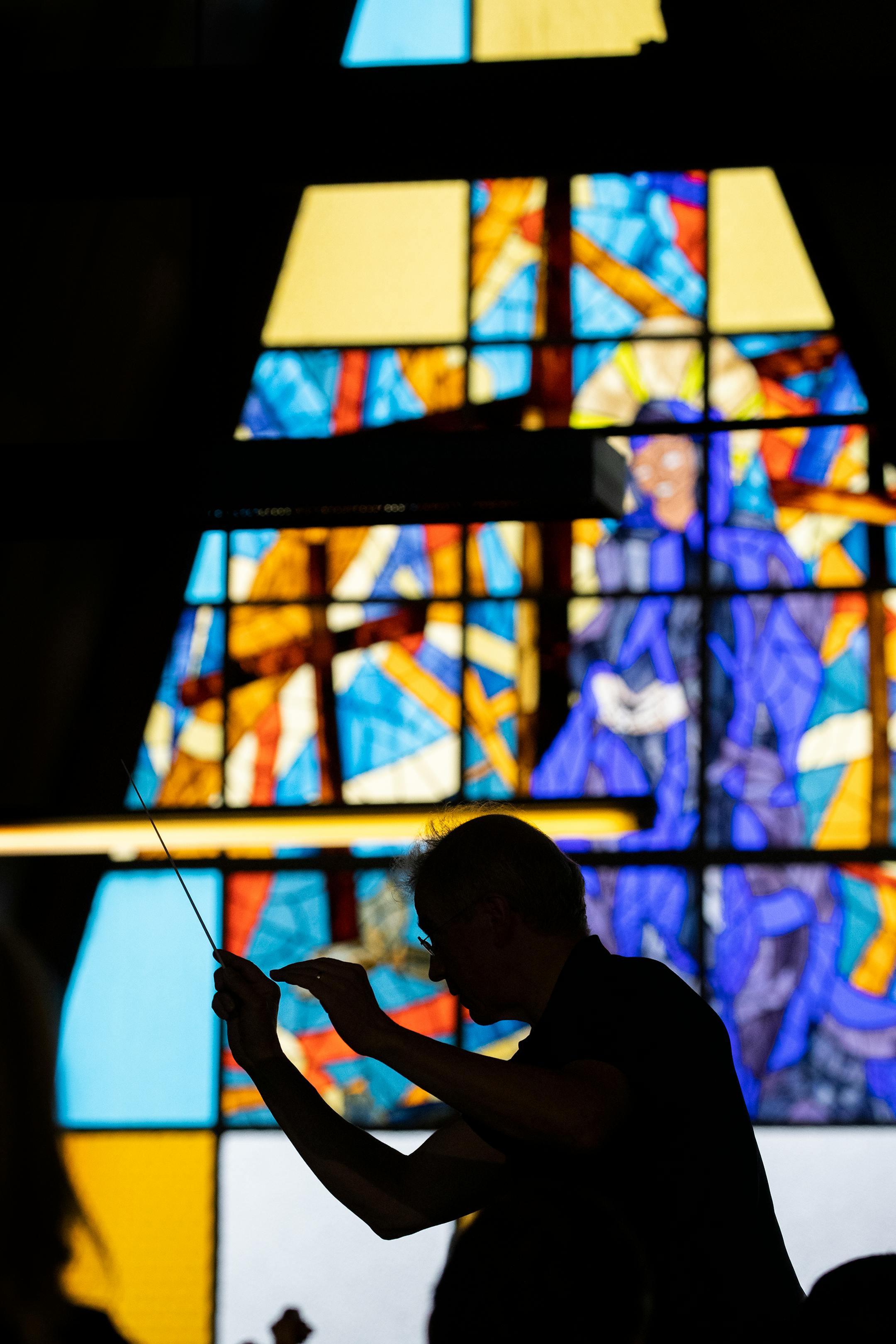 Vänskä, silhouetted in stained glass, during a rehearsal at Soweto's Regina Mundi Church on Aug. 17, 2018.