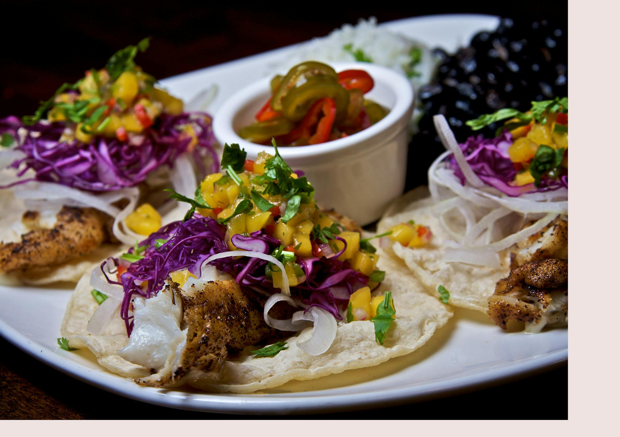 Señor Wong's Ensenada-style fish tacos are made with grilled Alaskan cod, red cabbage, shaved white onions, house-pickled jalapeños, mango salsa, black beans and cilantro-seasoned rice.