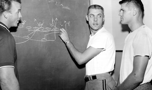September 21, 1957 Do It This Way -- In another Winnipeg Football office, Coach Bud Grant (center), former Minnesota end, charts a play for quarterbac