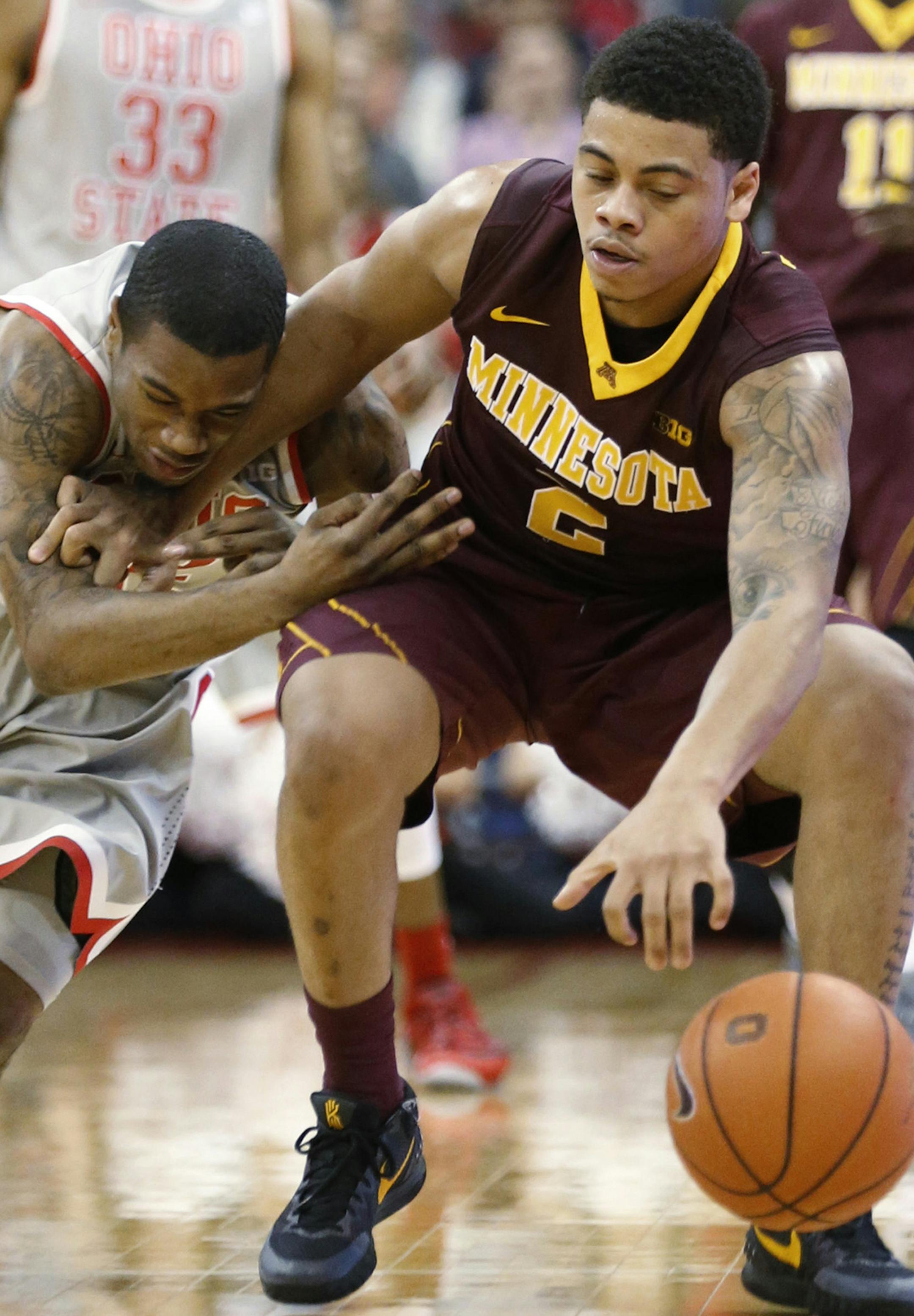 Ohio State's A.J. Harris (12) puts pressure on Minnesota's Nate Mason (2) during the second half at Value City Arena in Columbus, Ohio, on Wednesday, Dec. 30, 2015. Ohio State won, 78-63. (Fred Squillante/Columbus Dispatch/TNS)