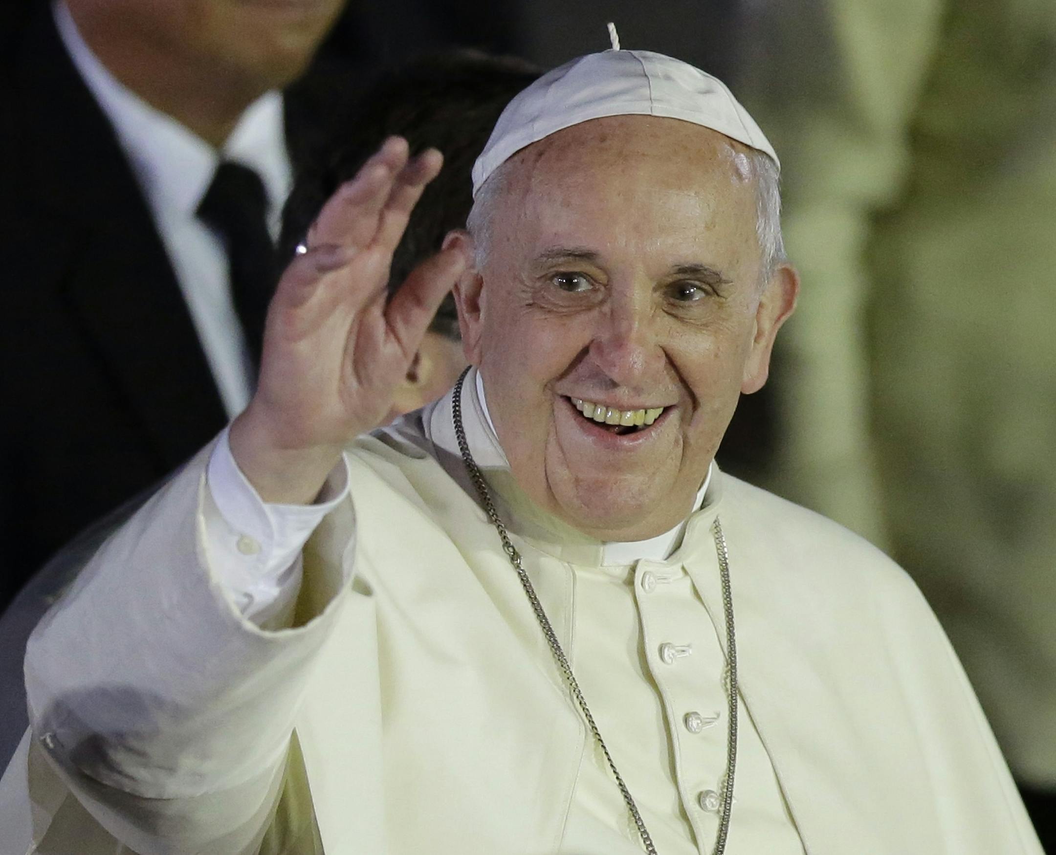 Pope Francis waves to well-wishers upon arrival from Sri Lanka, Thursday, Jan. 15, 2015 at suburban Pasay city, south of Manila, Philippines.