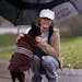 Tracy Hacker with her Boston terrier Fen at Maplewood's Wakefield Lake on a rainy evening in October , about a year after she was attacked with a base