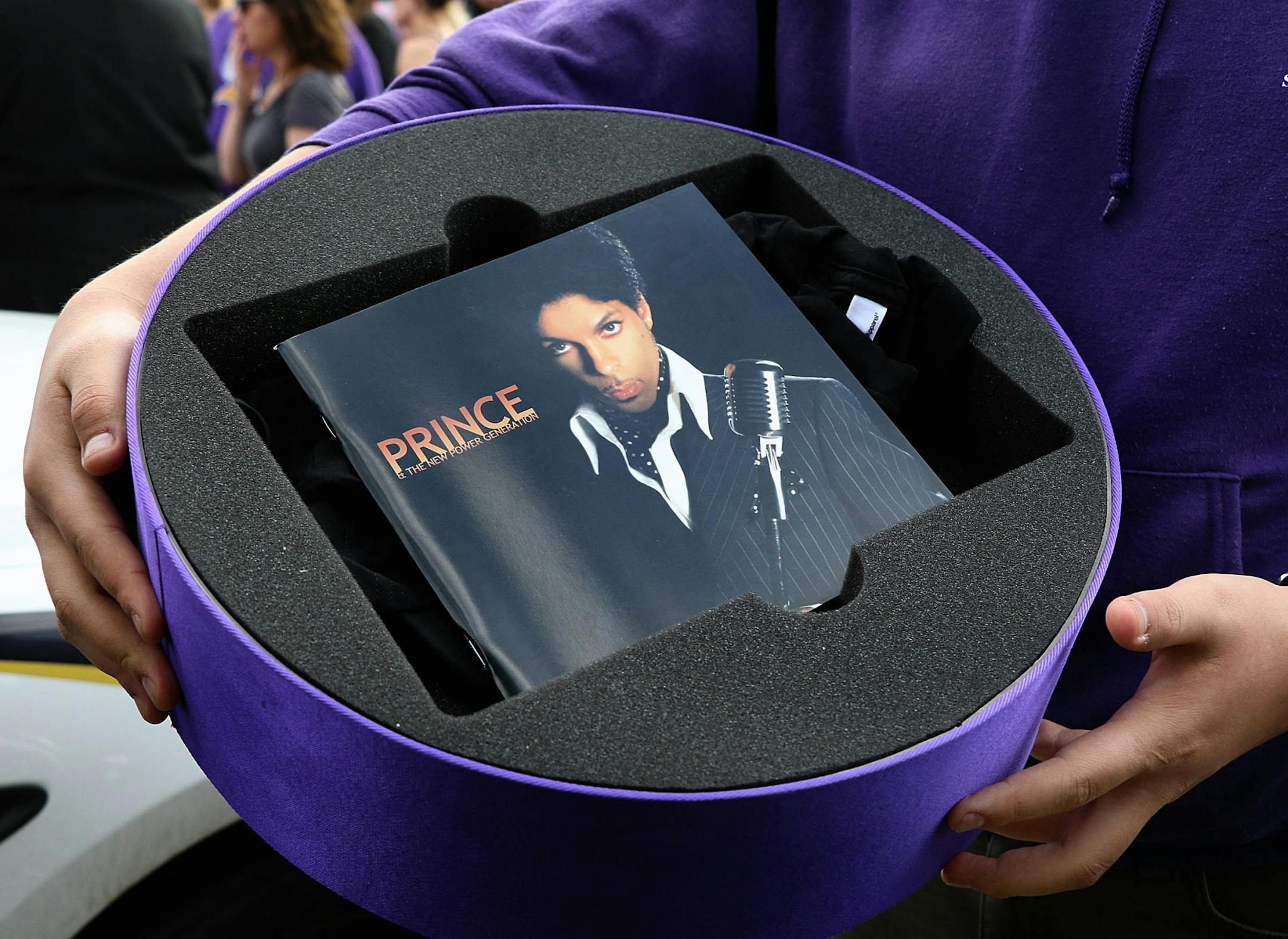 Garrett Whiterabbit-Decora, Wausau, WI, held a gift box he received while waiting outside Paisley Park in Chanhassen.