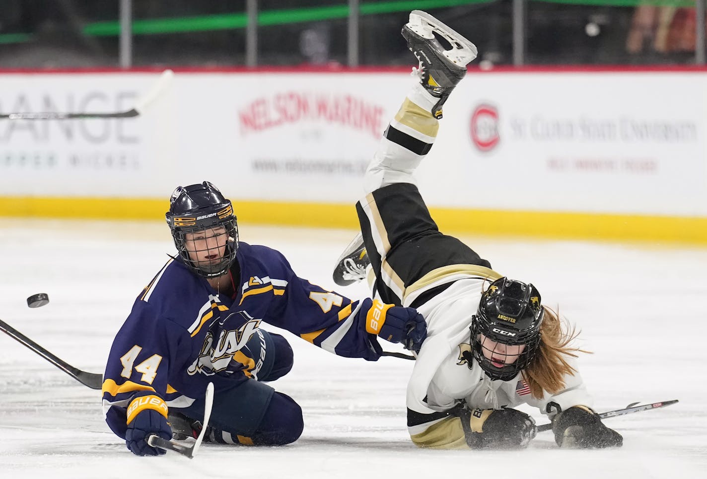 Rosemount defenseman Aubrey Finn (44) and Andover defenseman Ella Thoreson (2) collide in the neutral zone in the first period at Xcel Energy Center in St. Paul, Minn., on Thursday, Feb. 23, 2023. Rosemount faced Andover in a Class 2A quarterfinal. ] SHARI L. GROSS • shari.gross@startribune.com