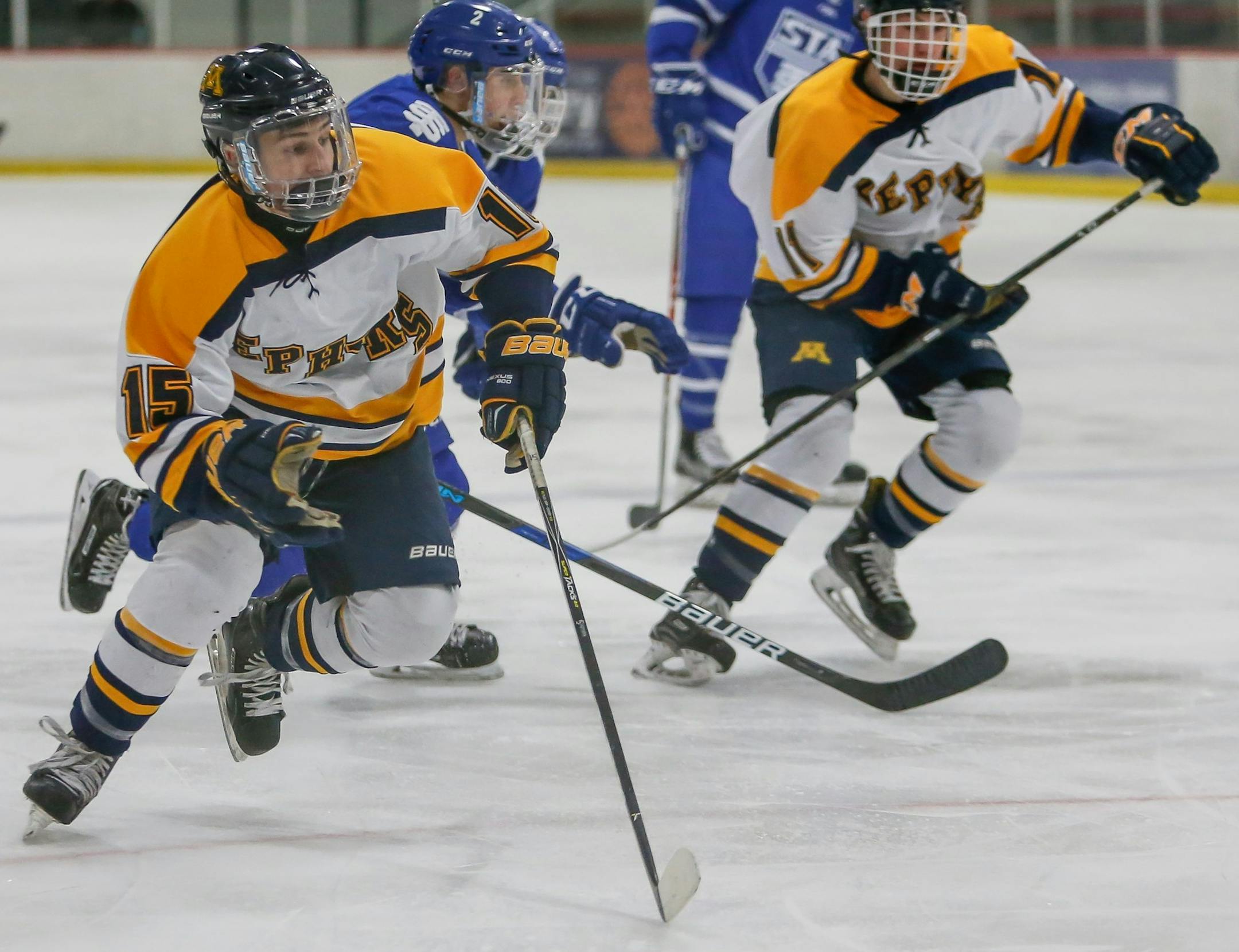 Mahtomedi seniors Sam Jenson (15) and Jeff Kneale (11), St. Thomas Academy at Mahtomedi, boys' hockey, 2-6-18. Photo by Mark Hvidsten, SportsEngine