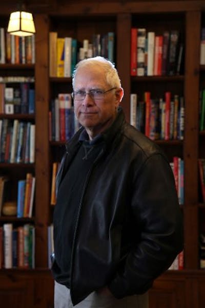 John Sandford in his home library.