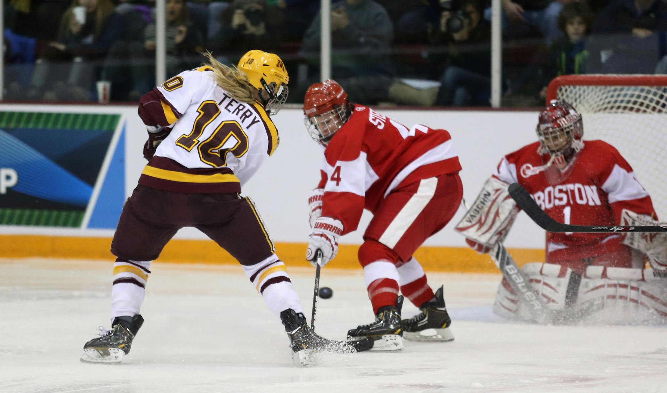 Gopher Kelly Terry took a slap shot Boston University Sarah Steele during the third period. ] (KYNDELL HARKNESS/STAR TRIBUNE) kyndell.harkness@startribune.com Gopher women's hockey played Boston University in the quarterfinals of the NCAA championship at Ridder Arena in Minneapolis, Min, Saturday March 15, 2014. Gophers won over Boston University 5-1.