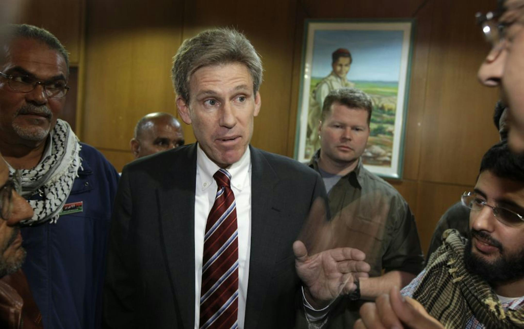 FILE - In this Monday, April 11, 2011 file photo, U.S. envoy Chris Stevens speaks to local media at the Tibesty Hotel where an African Union delegation was meeting with opposition leaders in Benghazi, Libya.