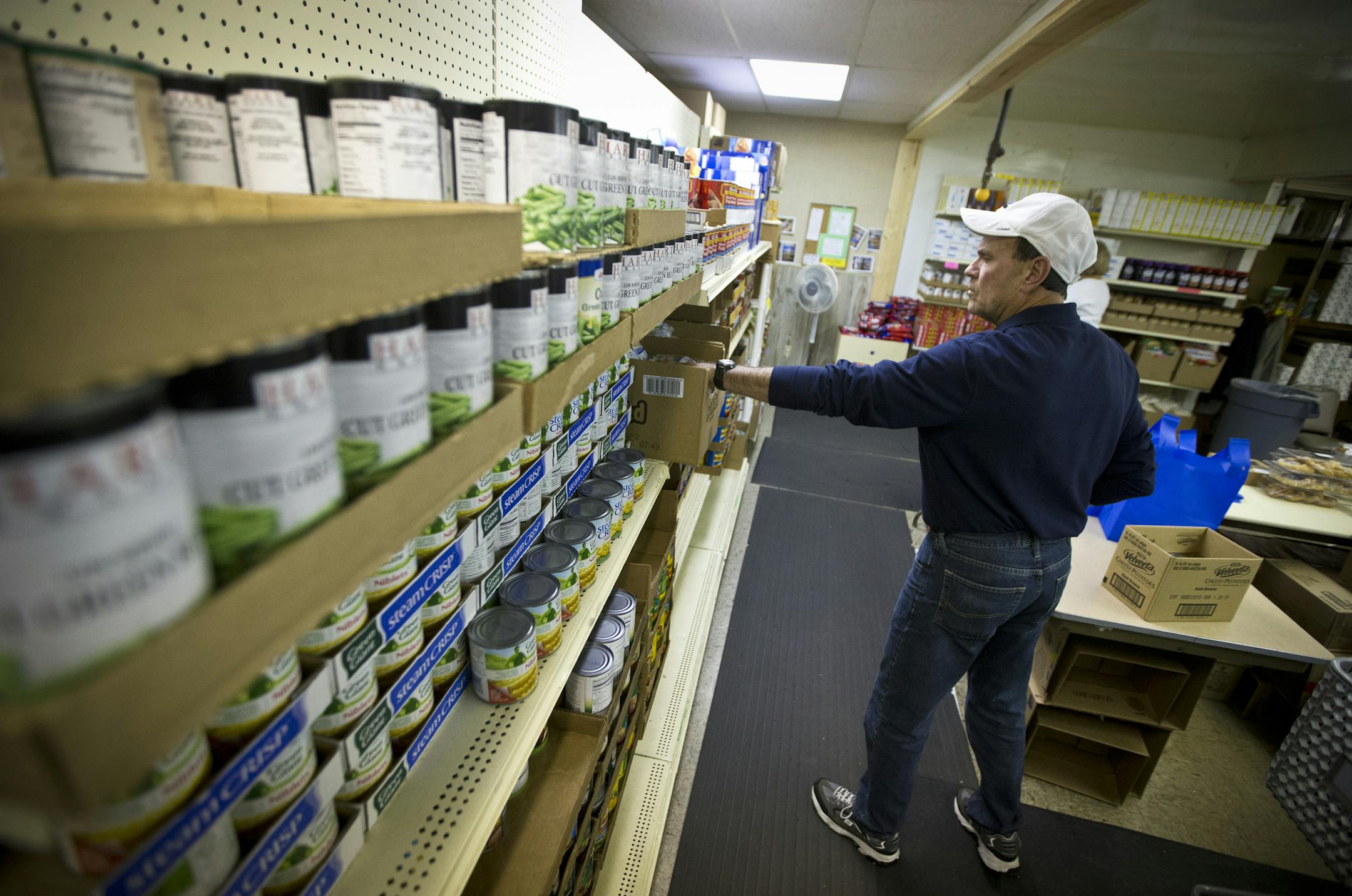 Volunteer Wayne Gale filled an order recently at Friends in Need food shelf in St. Paul Park.