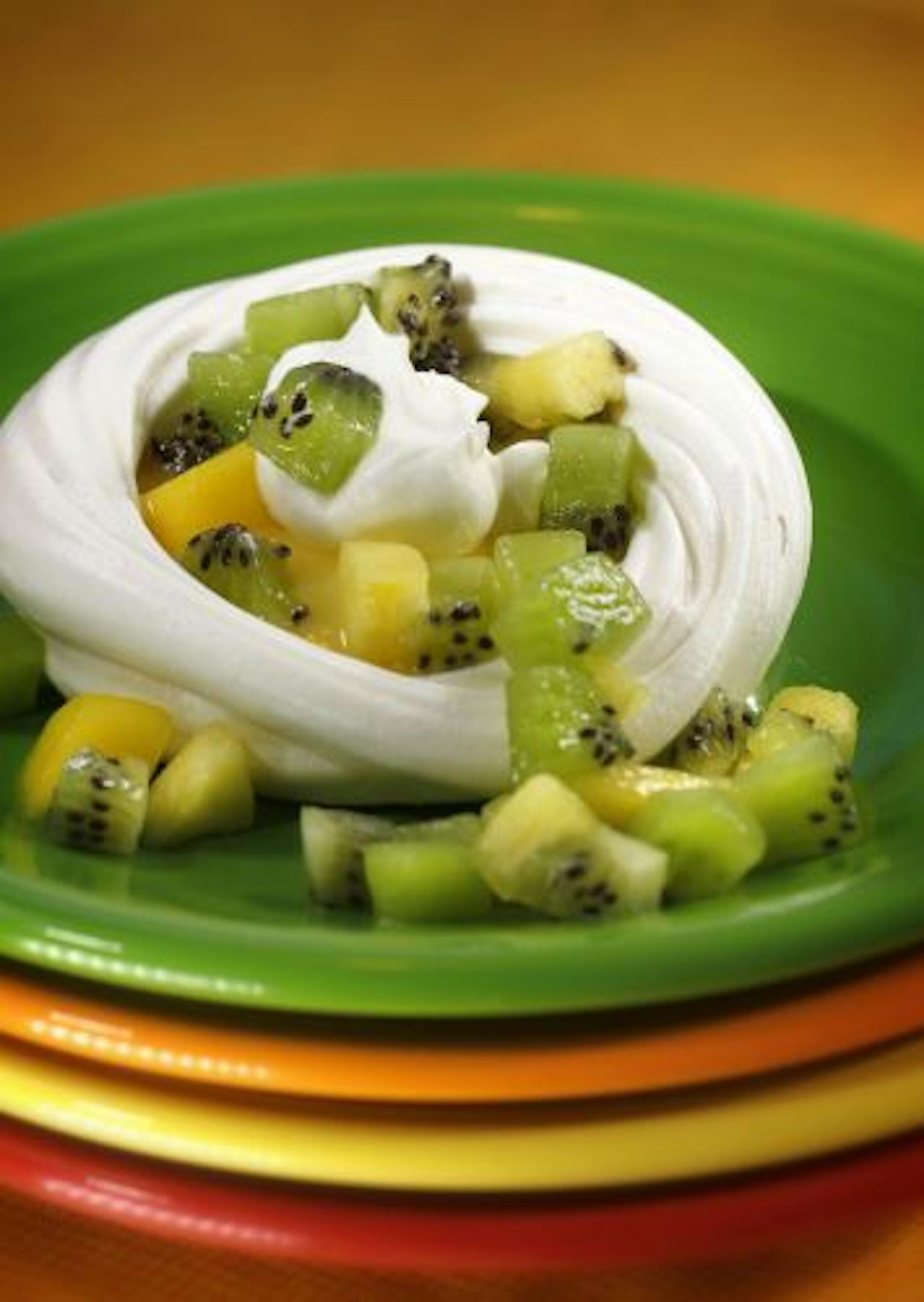 Light-as-air meringues filled with lemon curd and a tumble of fresh tropical fruits make an elegant dessert, with very little effort.