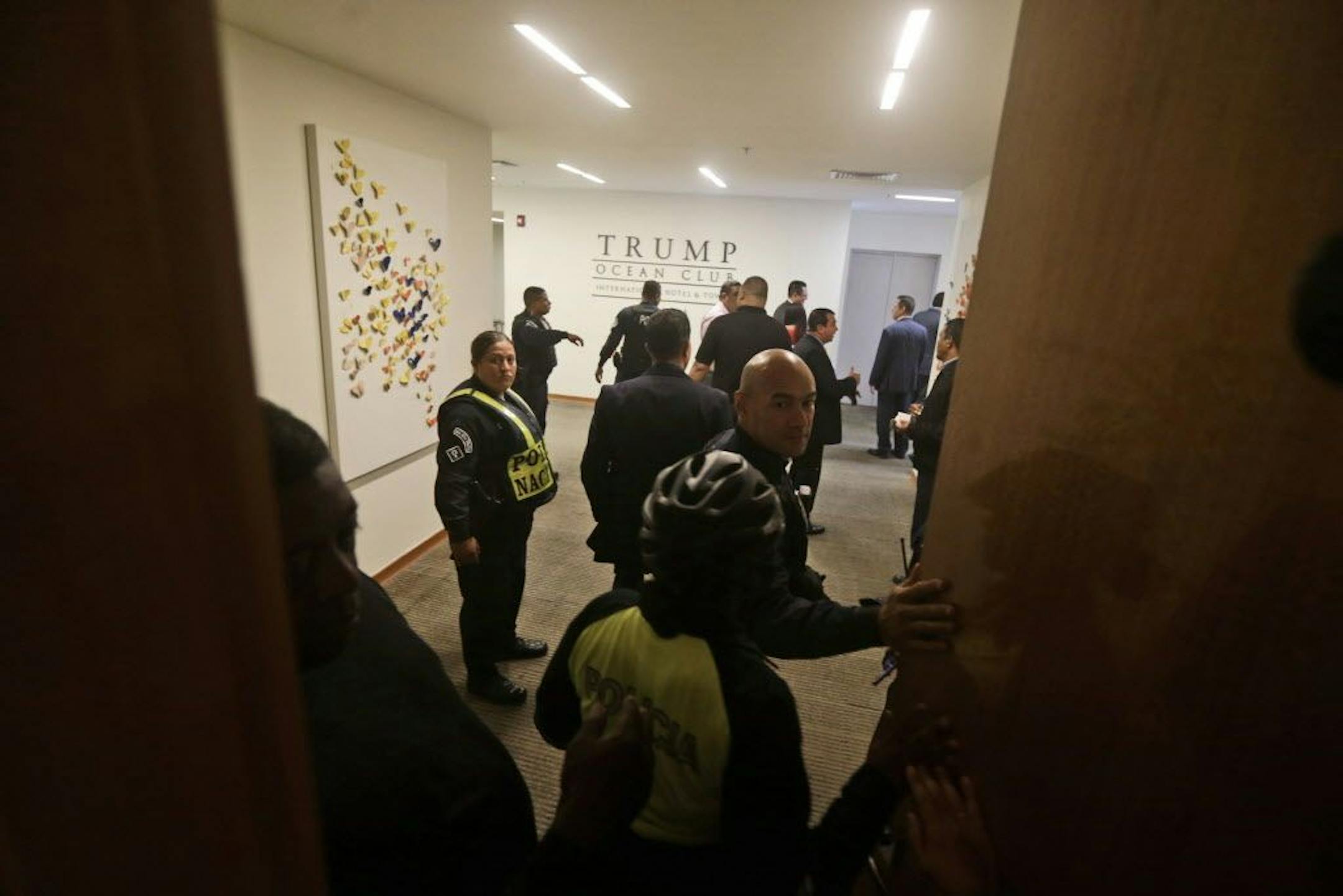 A group of Panamanian police officers stand inside the Trump Ocean Club International Hotel and Tower in Panama City, Monday, March 5, 2018. Escorted by police officers and a Panamanian judicial official, the owner of the Trump Panama City hotel has taken control of the property. A team of Trump security officials left the property.