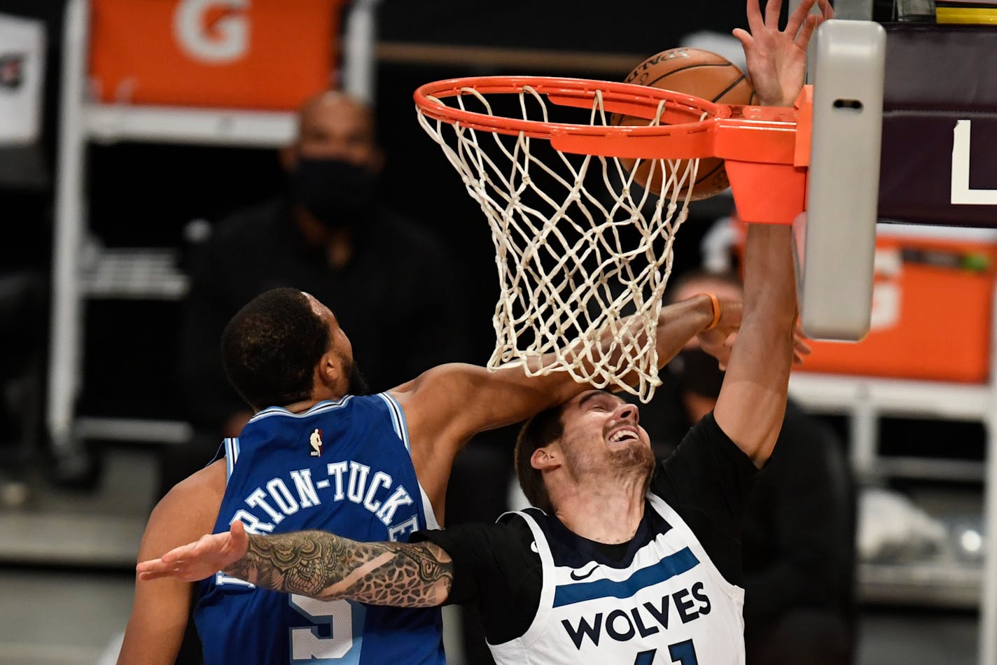 Los Angeles Lakers guard Talen Horton-Tucker, left, blocks a dunk attempt by Minnesota Timberwolves forward Juancho Hernangomez during the first half of an NBA basketball game in Los Angeles, Sunday, Dec. 27, 2020. (AP Photo/Kyusung Gong)