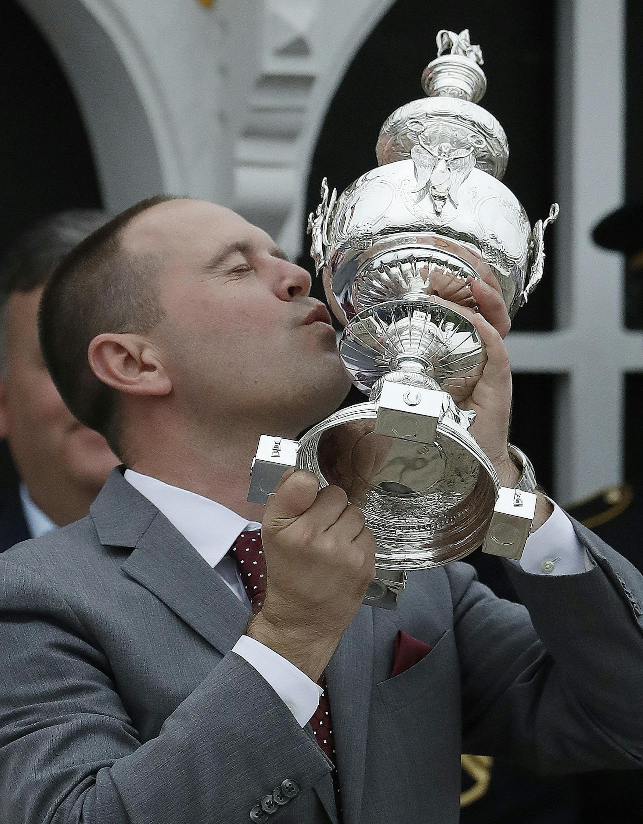Chad Brown the trainer for Cloud Computing celebrates with the Woodlawn Vase after the horse won the 142nd Preakness Stakes horse race at Pimlico race course, Saturday, May 20, 2017, in Baltimore. (AP Photo/Matt Slocum)