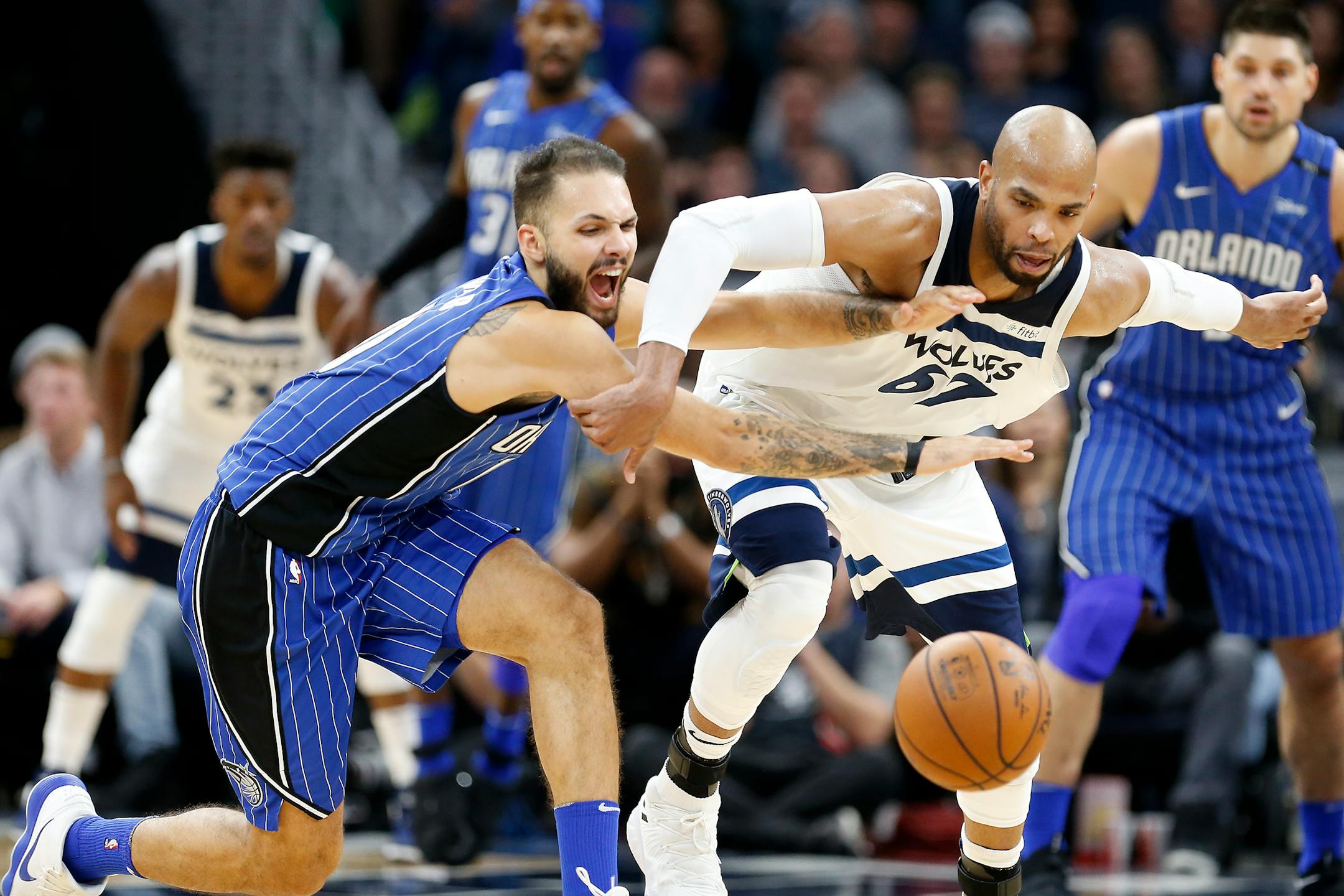Timberwolves forward Taj Gibson and Orlando forward Evan Fournier chase a loose ball during the second half.