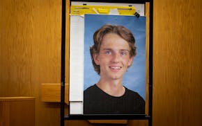 St. Croix County District Attorney Karl Anderson places a photo of 17-year-old Isaac Schuman in front of the jury during the Nicolae Miu trial in Huds