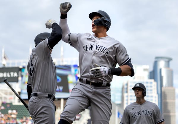 Aaron Judge (99) of the New York Yankees celebrates with teammates after hitting a home run in the first inning.