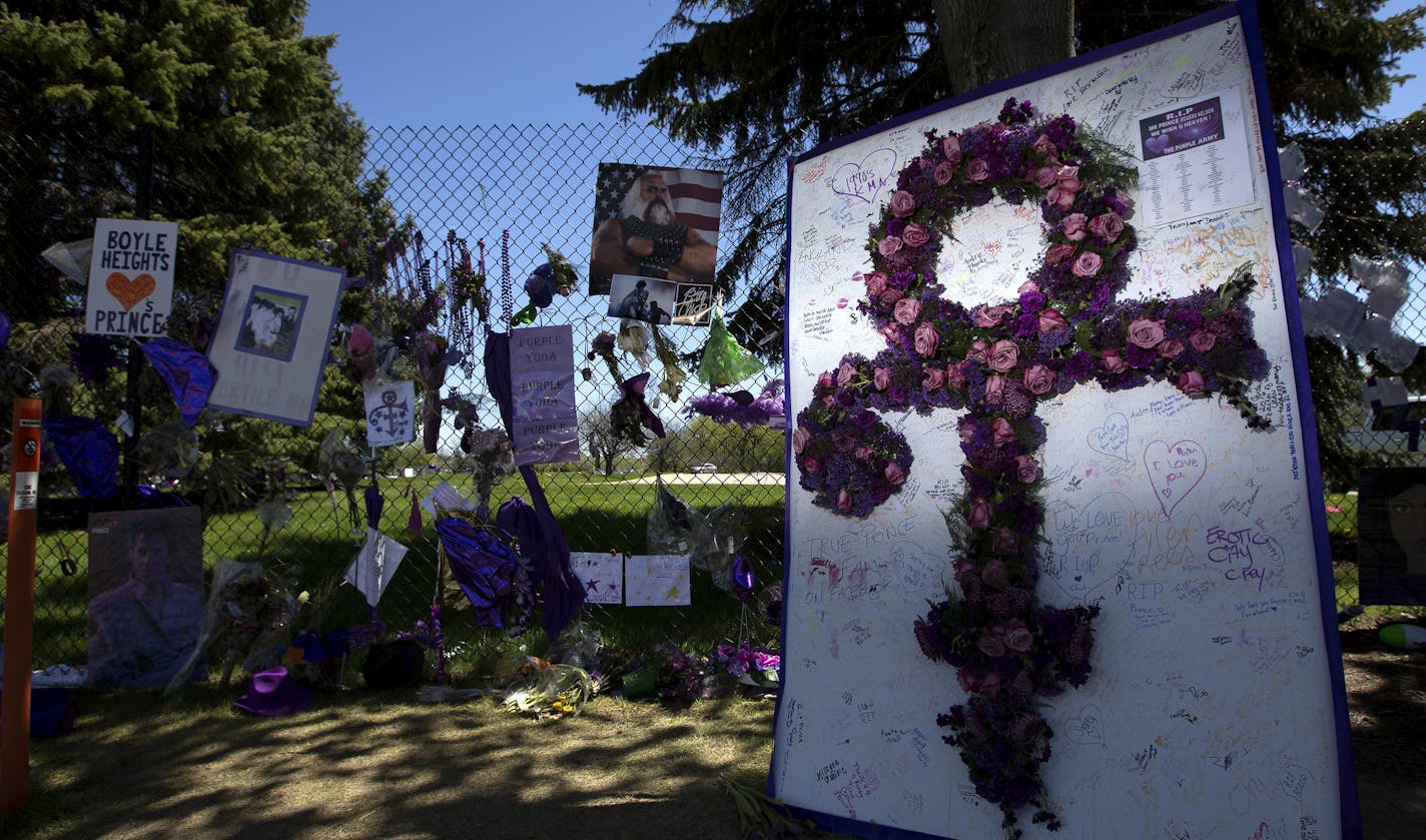 Balloons flowers and other mementos attached to the fence and trees surrounding Paisley Park in Chanhassen, MN honoring the death of Prince. ] CARLOS GONZALEZ cgonzalez@startribune.com - May 4, 2016, Chanhassen MN, Paisley Park, Prince, Following Prince death investigation