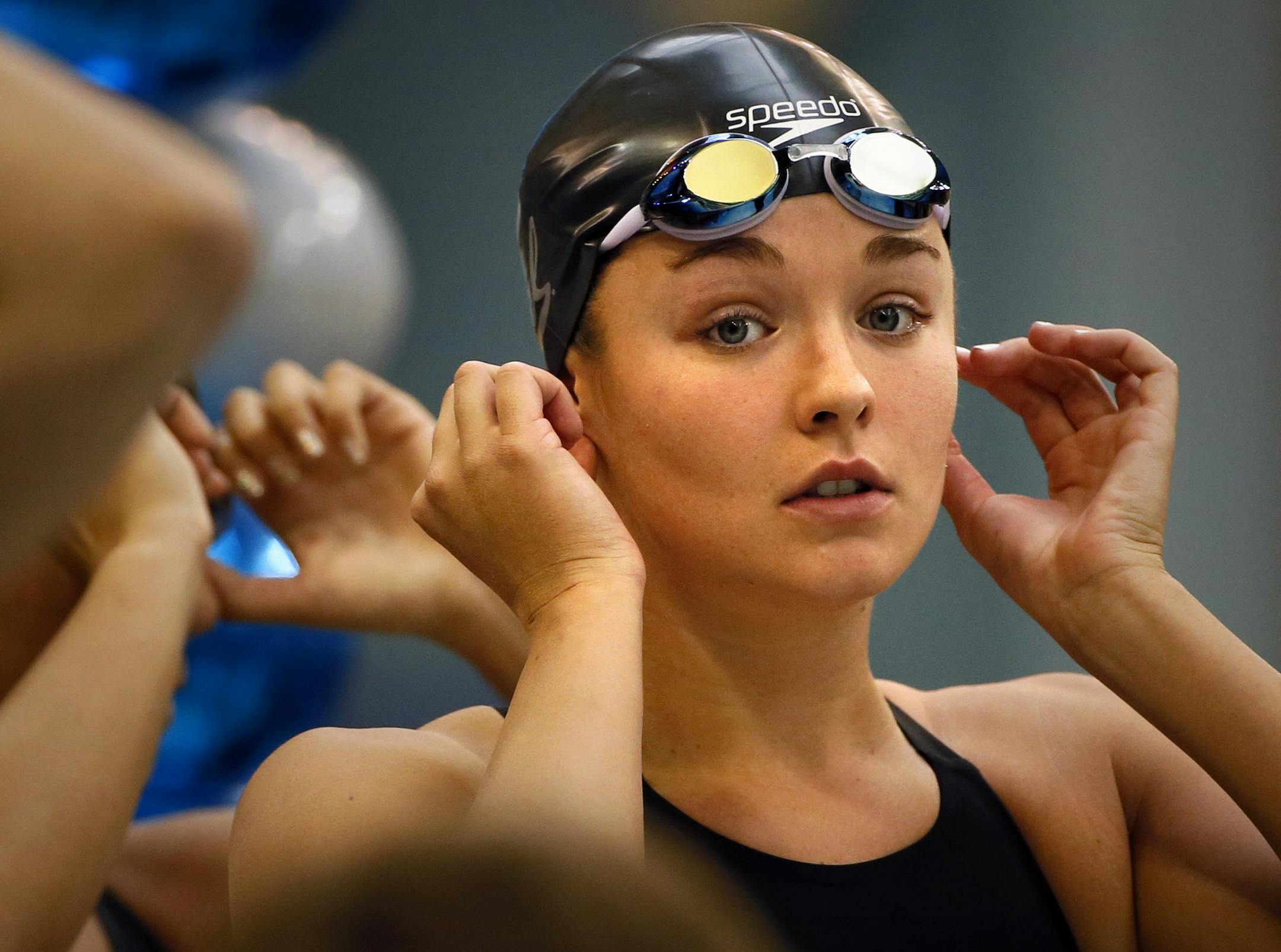 Former Eden Prairie swimmer Rachel Bootsma, now swimming for CAL in the NCAA National Championships at the Uof M, prepares for her first event, prelims of the 200 yard freestyle relay. Here, Bootsma checks her earings before the race like she has done every race before. They were her grandmothers. ] BRIAN PETERSON ‚Ä¢ brian.peterson@startribune.com Minneapolis, MN 3/20/2014
