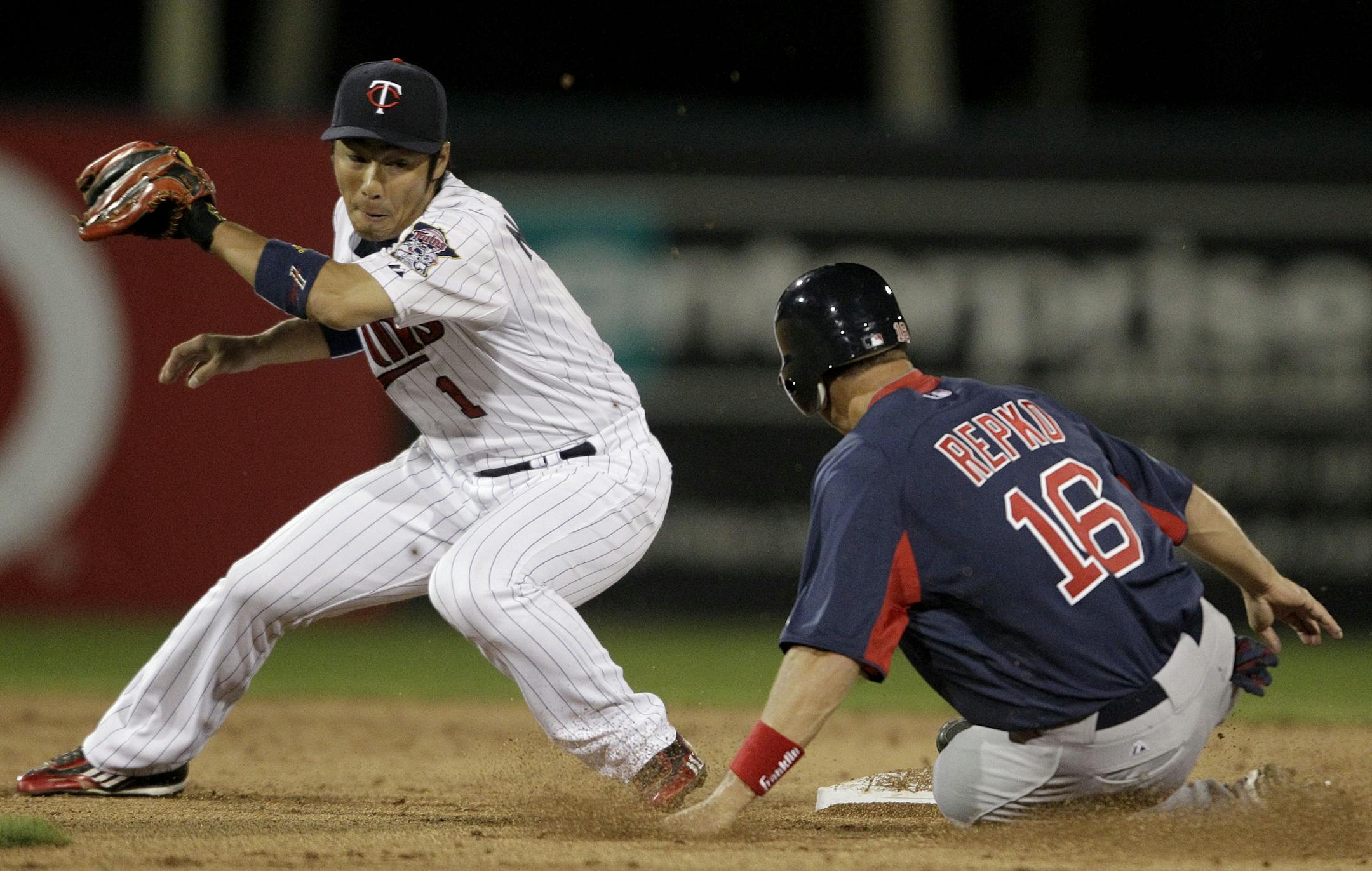 Boston Red Sox's Jason Repko, right, steals second base as Minnesota Twins shortstop Tsuyoshi Nishioka, of Japan, is late on the play during the second inning of a spring training baseball game Monday, March 5, 2012, in Fort Myers, Fla.