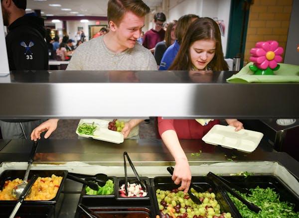 On their plates: Isaiah Damitz and Ellie Boisen went through the lunch line at Owatonna High School, taking the requisite mix of healthful options. Re