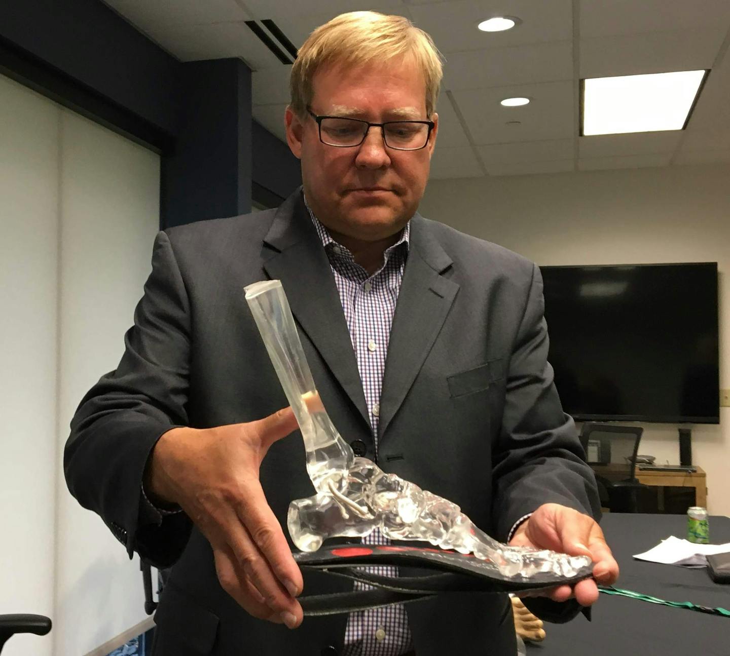 Owatonna podiatrist Dr. Barry Butler holds a working mockup of his invention, the SubioMed shoe insert, which uses layers of flexible carbon fiber pads to create what the company calls &#x201c;suspension biomechanics&#x201d; within the user&#x2019;s shoe. The system, not yet for sale, can be customized for a patient&#x2019;s specific needs after surgery on the feet and ankles, but it may one day be available as standardized over-the-counter consumer device to prevent lower-body biomechanical pro