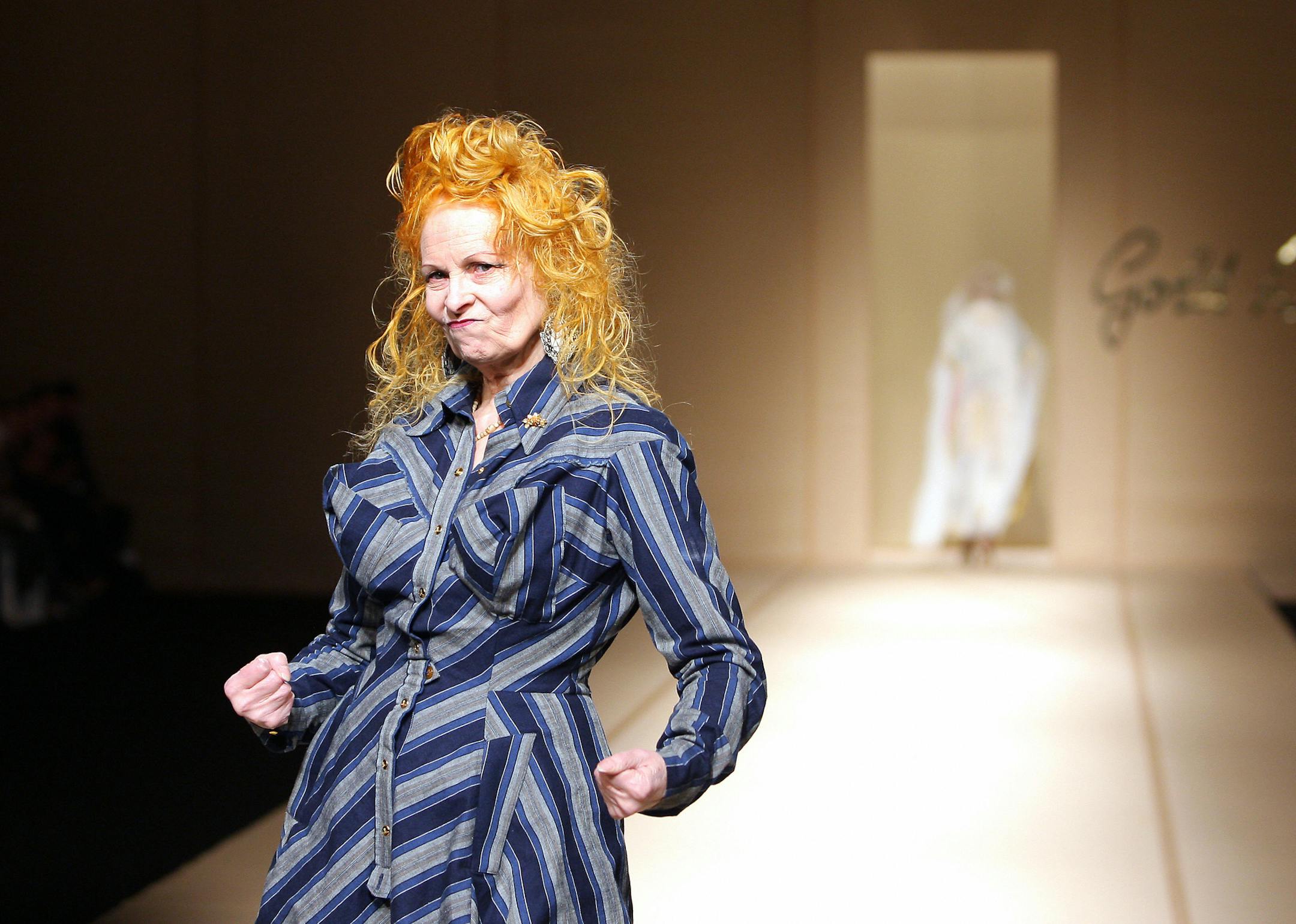 British designer Vivienne Westwood acknowledges the public at the end of Spring/Summer 2008 ready-to-wear collection show in Paris, 01 October 2007. AFP PHOTO PIERRE VERDY (Photo credit should read PIERRE VERDY/AFP/Getty Images) ORG XMIT: -