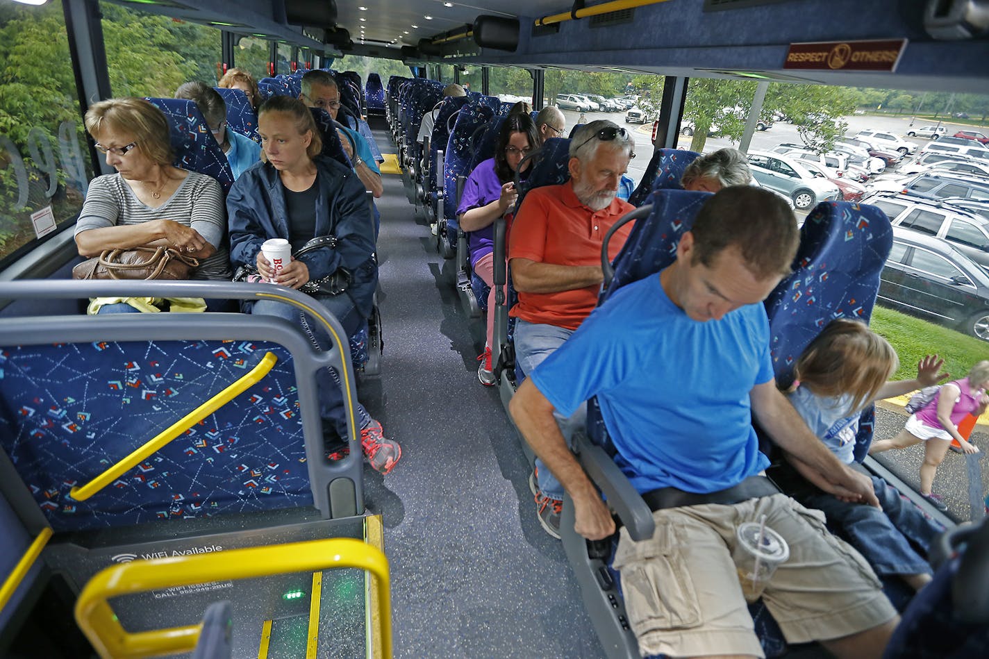 Passengers en route to the State Fair made their way onto a Southwest Transit double decker bus, Friday, August 29, 2014 in Eden Prairie, MN. The company is running the first double decker buses in the Twin Cities. They've wanted them for awhile but couldn't get because none were made in the US. ] (ELIZABETH FLORES/STAR TRIBUNE) ELIZABETH FLORES &#x2022; eflores@startribune.com