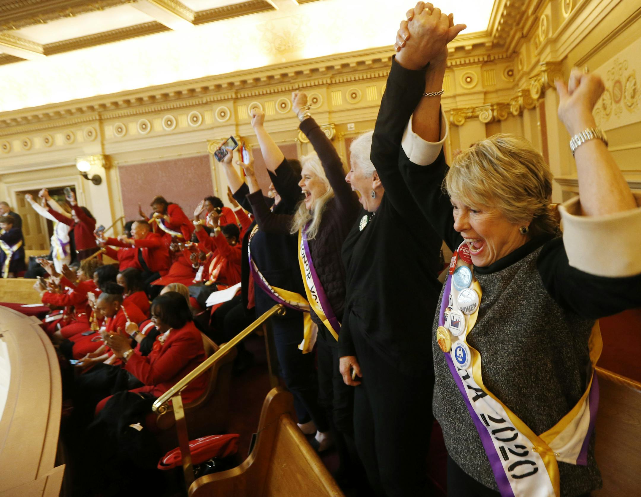 Equal Rights Amendment supporter Donna Granski, right, from Midlothian Va., cheers the passage of the House ERA Resolution in the Senate chambers at the Capitol in Richmond, Va. Monday, Jan. 27, 2020. The resolution passed 27-12. (AP Photo/Steve Helber)