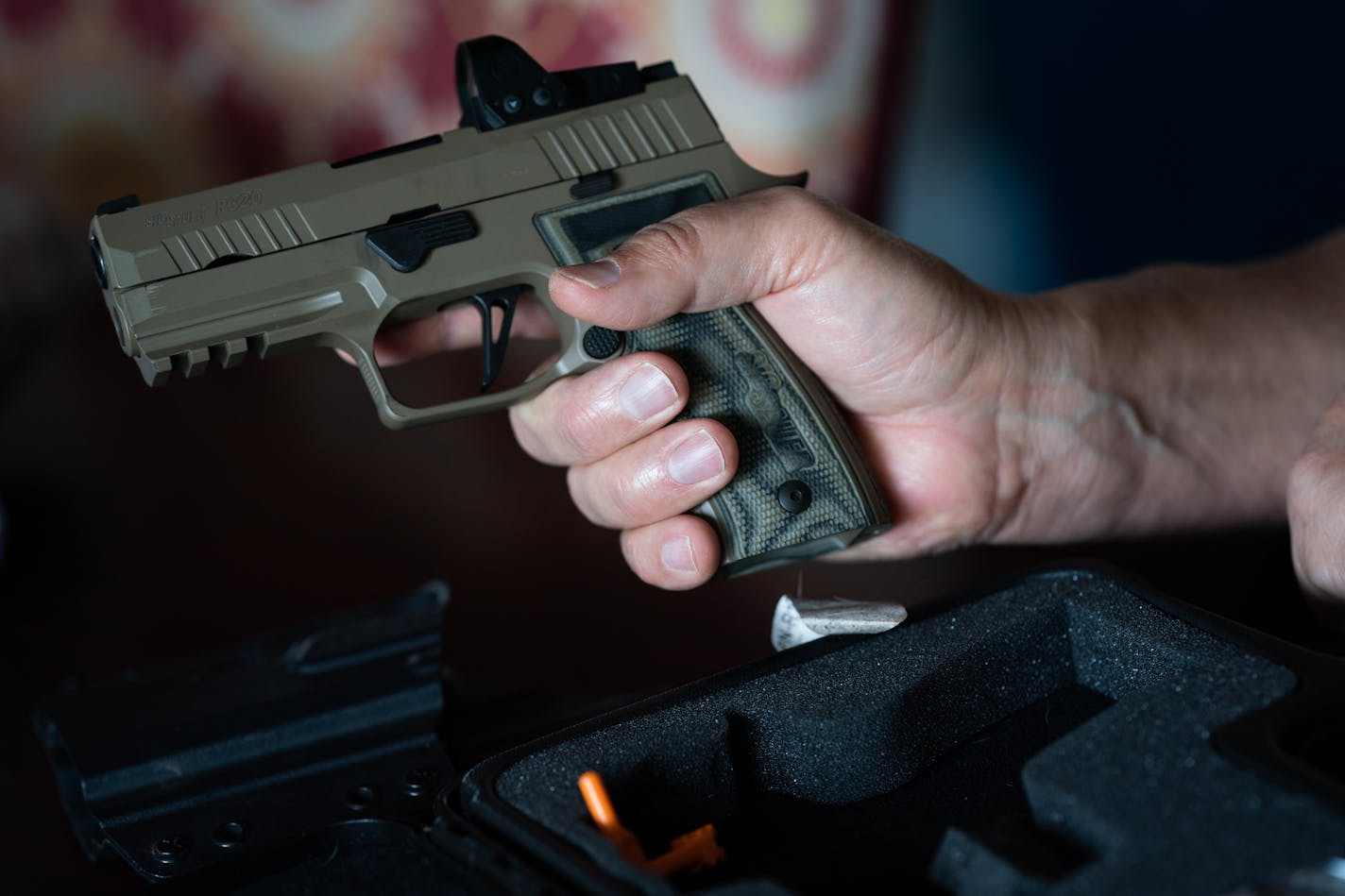 Man holding his P320.