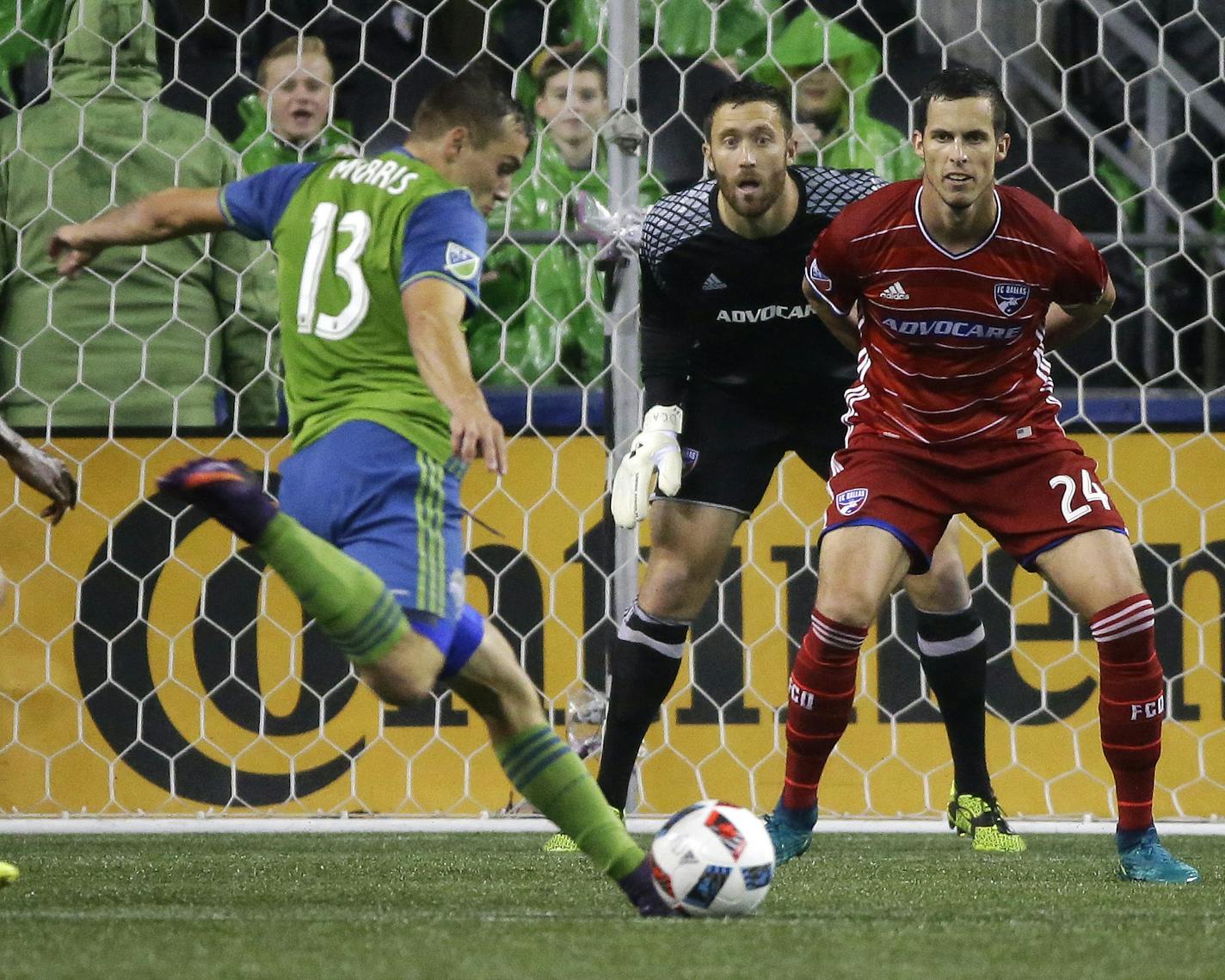 Seattle Sounders forward Jordan Morris (13) takes a shot on goal that was saved by FC Dallas goalkeeper Chris Seitz, center, as FC Dallas defender Matt Hedges, right, looks on in the first half of an MLS soccer playoff match, Sunday, Oct. 30, 2016, in Seattle. (AP Photo/Ted S. Warren)