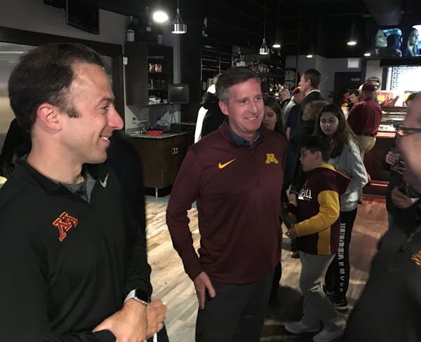 Men's basketball coach Richard Pitino, left, and athletic director Mark Coyle mixed and mingled with fans at the Gophers coaches caravan tour stop in 
