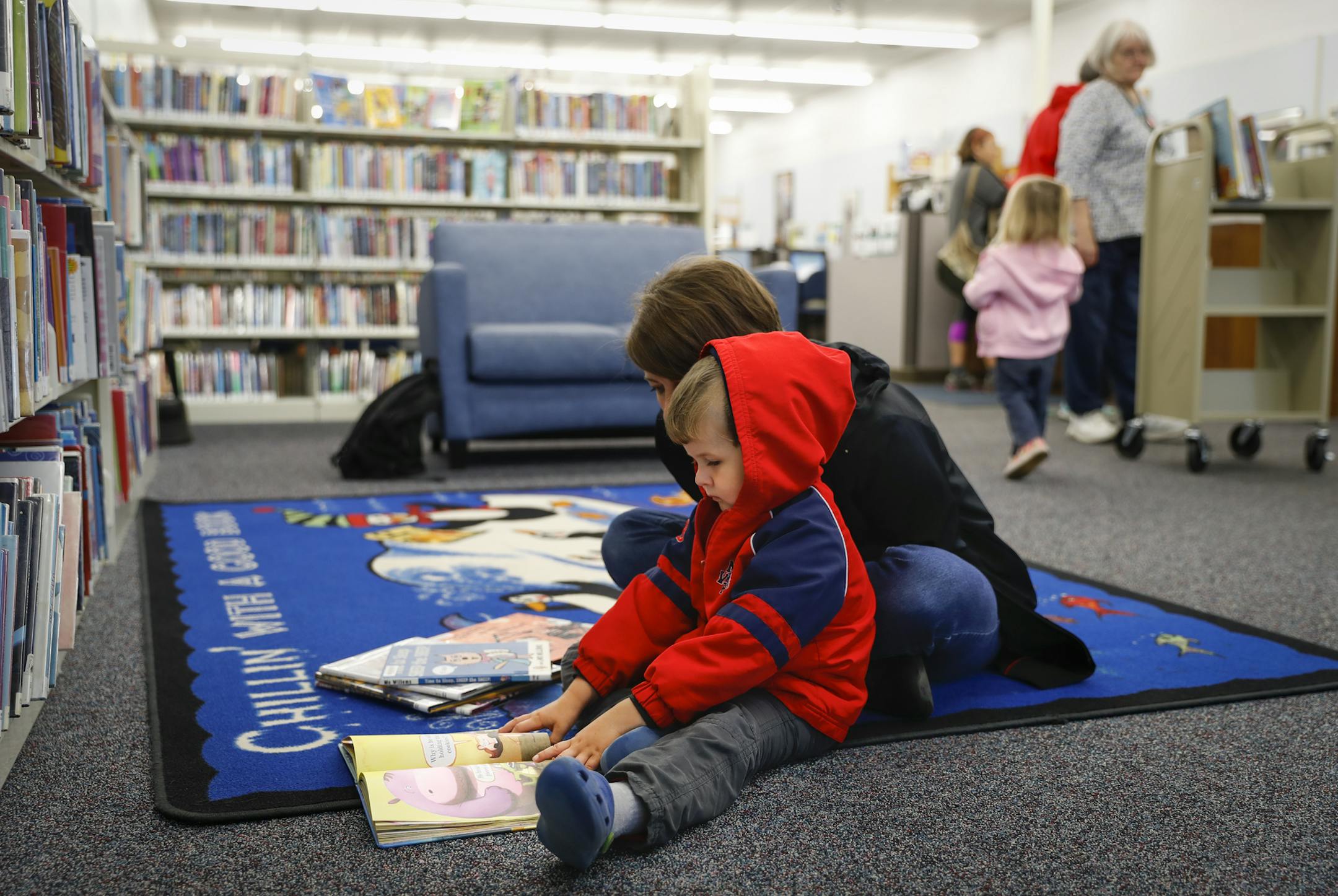 Amy Lahr read a book with her son Corwin Lahr while at Valley Library for children's story time on Monday, September 18, 2017, Lakeland, Minn. ] RENEE JONES SCHNEIDER • renee.jones@startribune.com