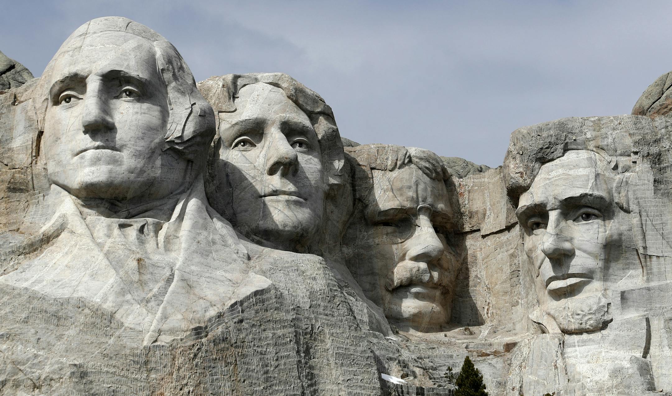 FILE - This March 22, 2019, file photo shows Mount Rushmore in Keystone, S.D. Organizers have scrapped plans to mandate social distancing during President Donald Trump's appearance at a July 3, 2020, Mount Rushmore fireworks display and won't limit the crowd due to coronavirus concerns, South Dakota Gov. Kristi Noem said Thursday, June 4, 2020. The Republican governor said the National Park Service is dolling out 7,500 tickets via lottery for the event, which marks the first time in a decade tha