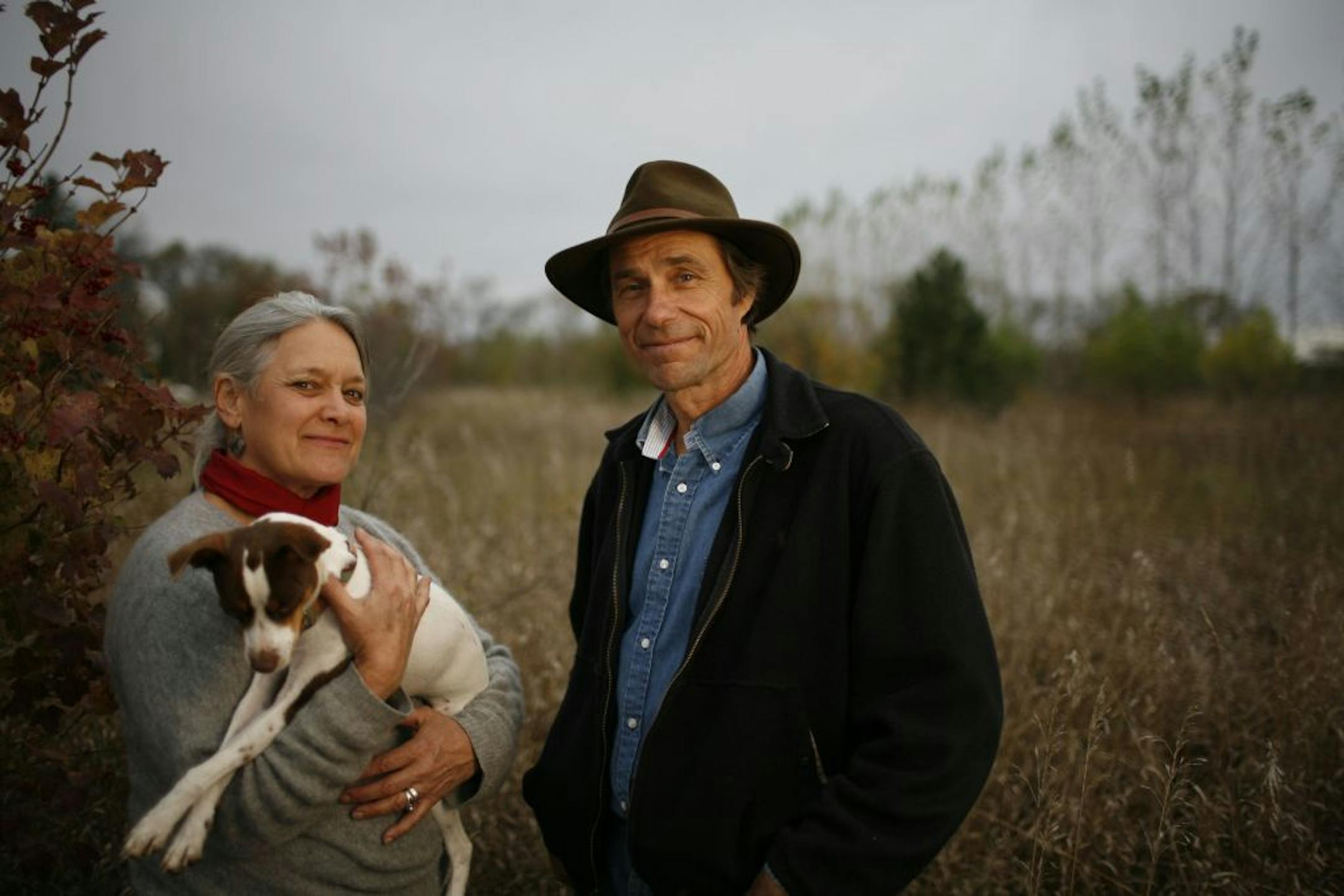 Audrey Arner, holding Abby, and husband Richard Handeen go against the norm on their Moonstone Farm near Montevideo by raising grass-fed cattle.