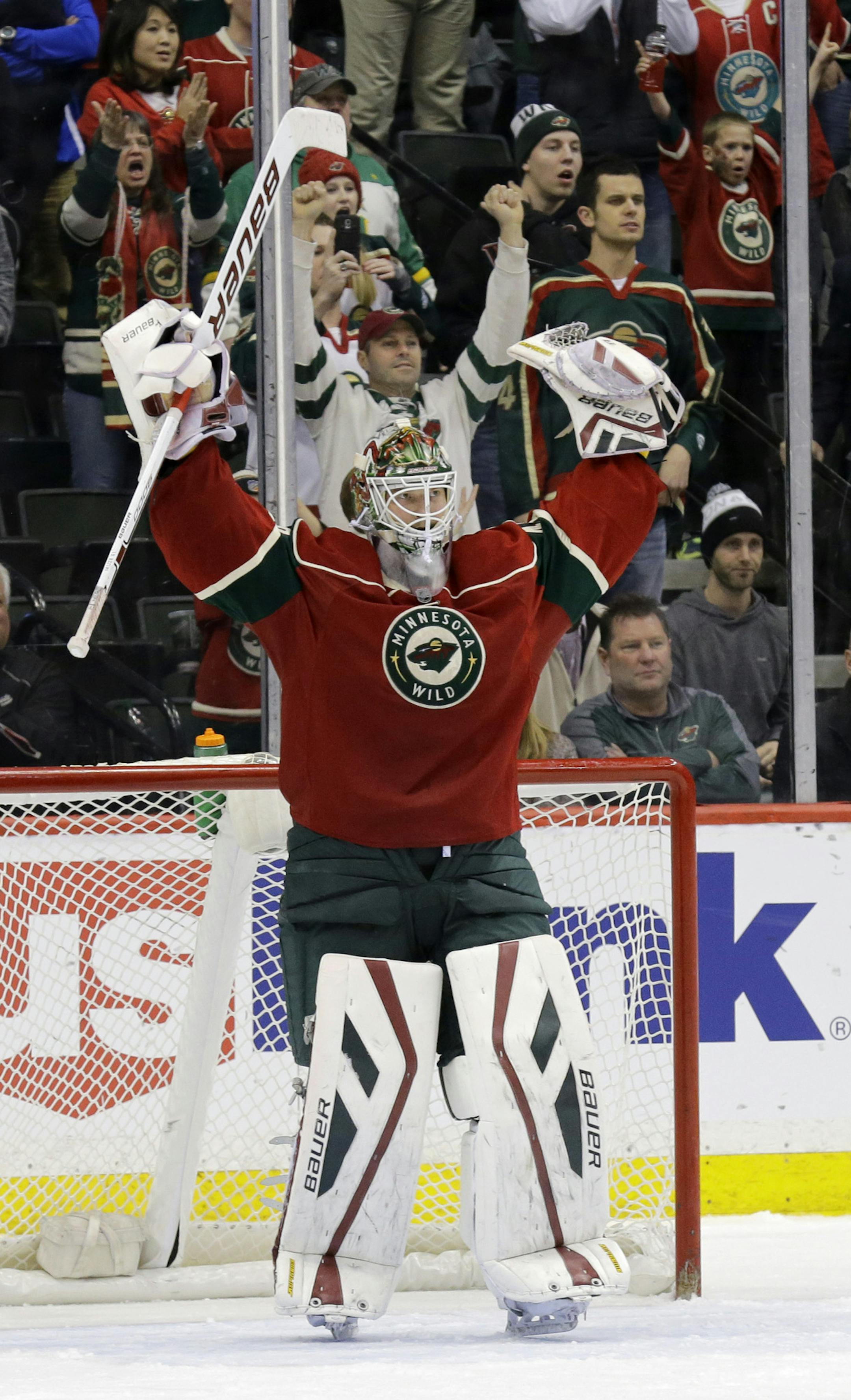 Minnesota Wild goalie Devan Dubnyk celebrates after his team defeated the Colorado Avalanche 1-0 in an NHL hockey game in St. Paul, Minn., Saturday, Feb. 7, 2015. (AP Photo/Ann Heisenfelt)