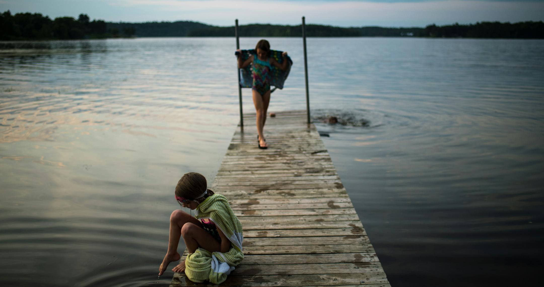 Haley Cosert, 6, of Brainerd, dipped her toes into the water as her sister, Emelia, 9, dried off after swimming in Rice Lake, a small lake formed on the edge of the Mississippi River in Brainerd, in mid August. ] (AARON LAVINSKY/STAR TRIBUNE) aaron.lavinsky@startribune.com RIVERS PROJECT: We look at three of Minnesota's rivers, including the Mississippi, Red and Chippewa, to see how land use effects water quality and pollution.