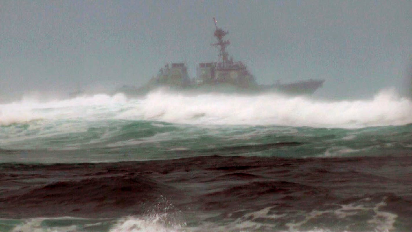 A search vessel cruised the waters off the beach at Haleiwa, Hawaii, as part of a search for missing Marines after a helicopter crash.