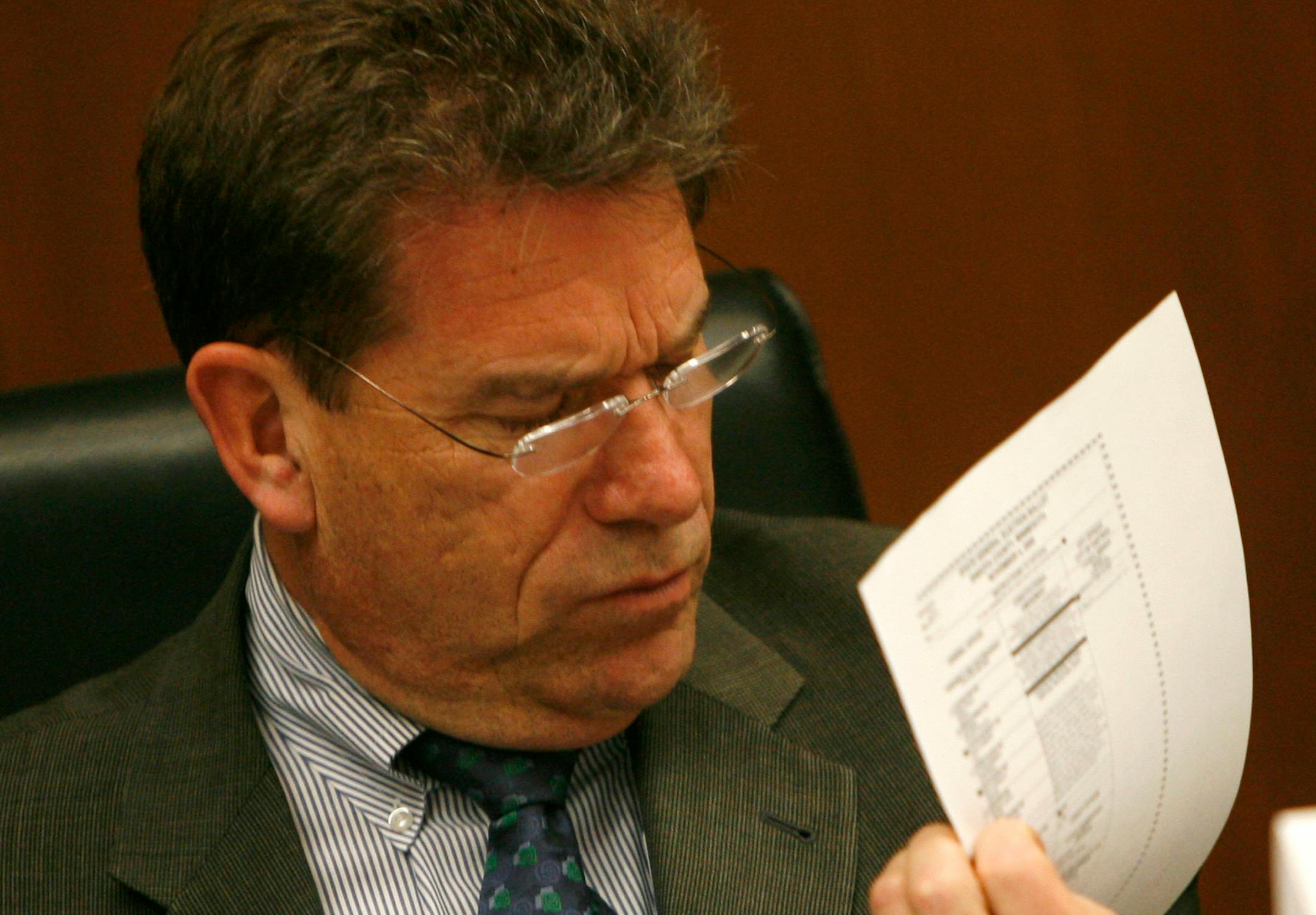 A challenged ballot is examined by Mark Ritchie, Chair and Secretary of State, as the State Canvassing Board met to resolve the disposition of the challenged ballots and to canvass the results of the recounts.