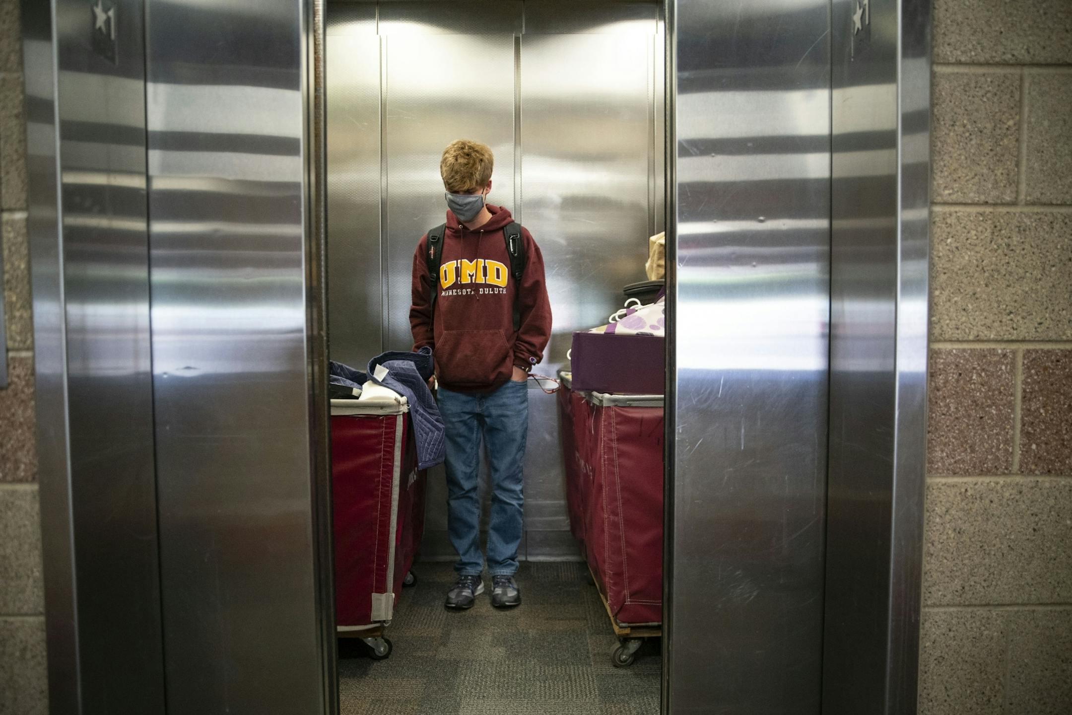 Jacob Reese stood in an elevator with carts holding all his belongings as he moved into Ianni Hall at UMD on Thursday.