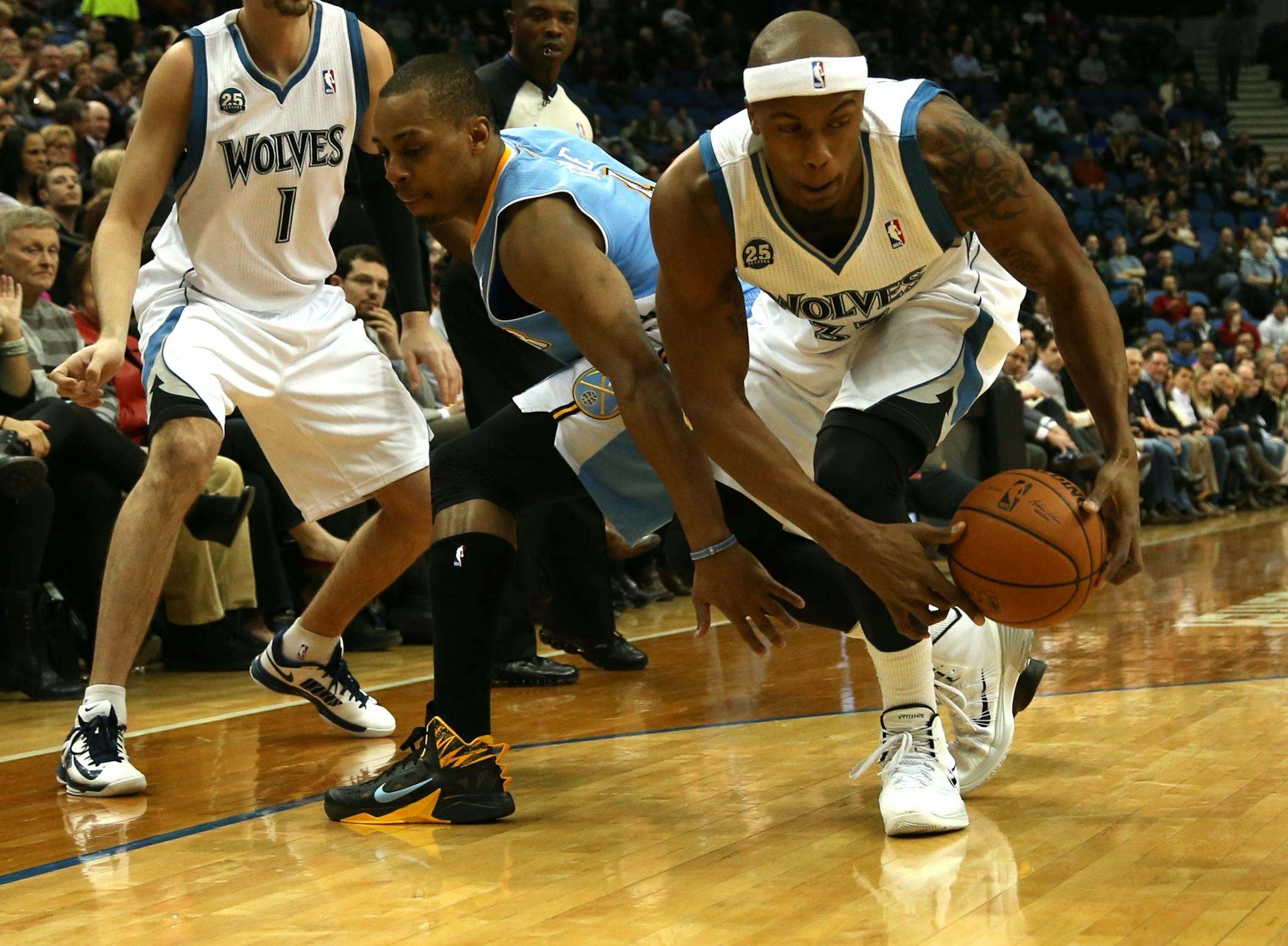 Wolves Dante Cunningham and Denver's Randy Foye fought over a loose ball during the first half at the Target Center in Minneapolis Wednesday, February 12, 2014.