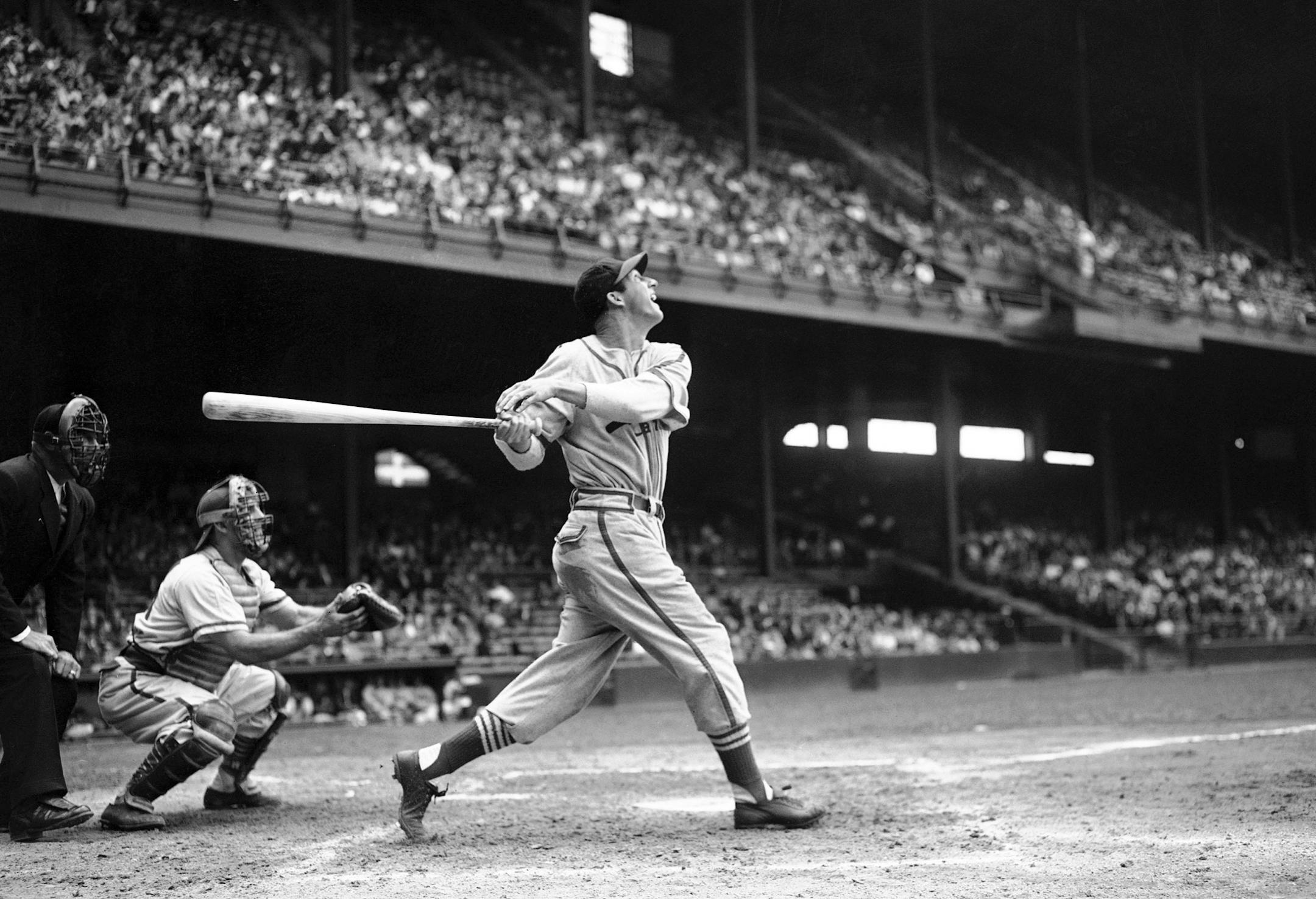 FILE - In this May 22, 1946 file photo, St. Louis Cardinals' Stan Musial bats against the Philadelphia Phillies during a baseball game at Shibe Park in Philadelphia, Pa. Musial, one of baseball's greatest hitters and a Hall of Famer with the Cardinals for more than two decades, died Saturday, Jan 19, 2013, the team announced. He was 92.