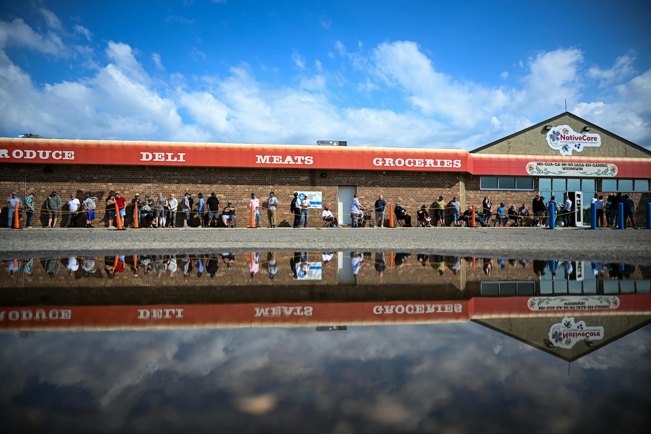 People line up before grand opening Tuesday, Aug. 1, 2023 at NativeCare recreational cannabis dispensary in Red Lake, Minn.