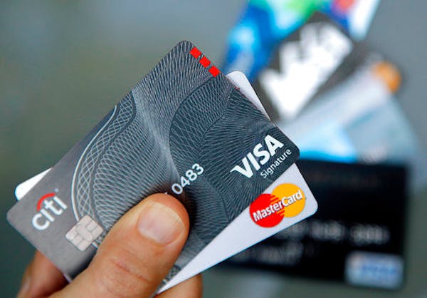 FILE - In this June 15, 2017, file photo, credit cards are displayed in Haverhill, Mass. Credit card tips might be easier to understand when they're b