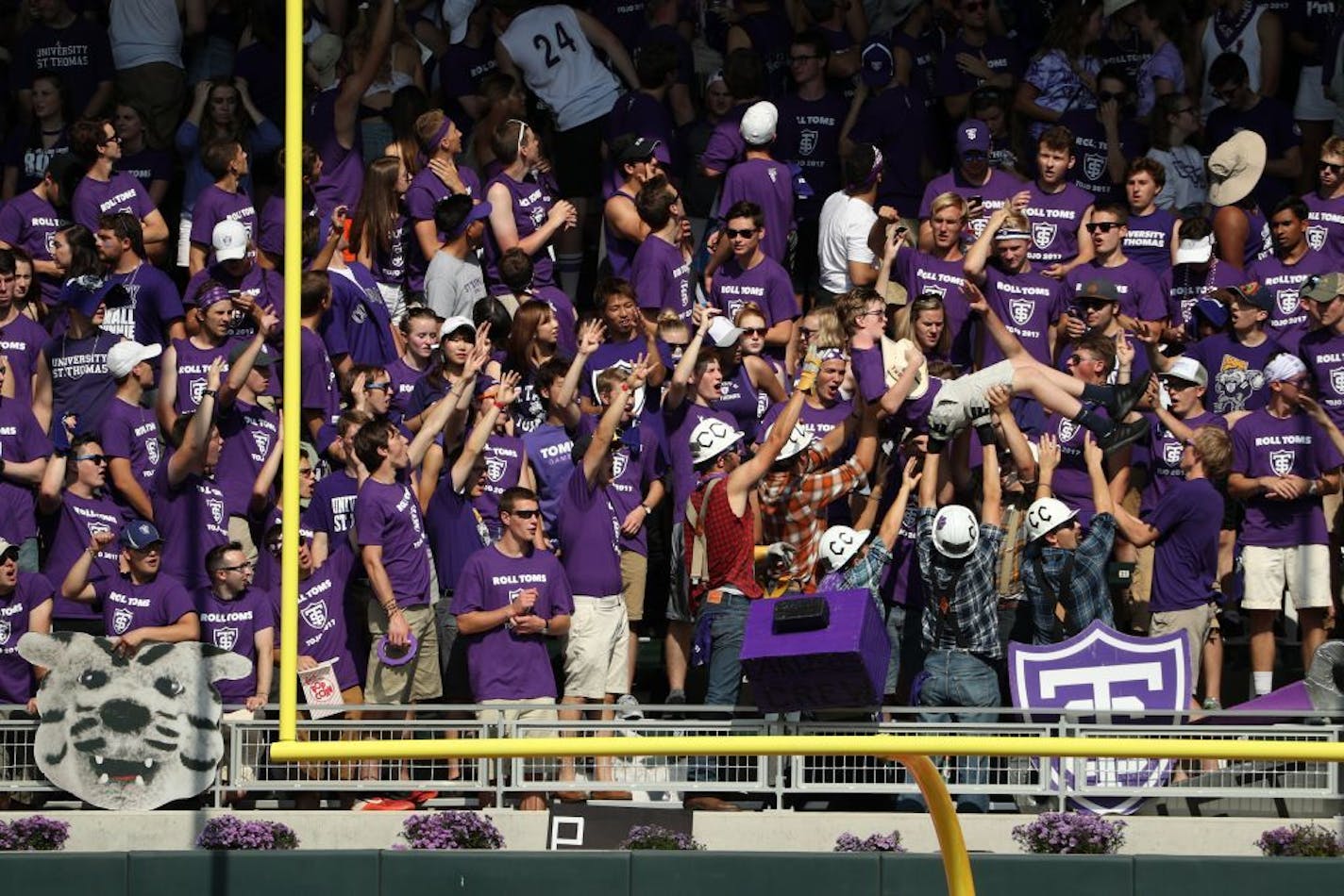 University of St. Thomas fans celebrated a touchdown against St. John's during their 2017 rivalry game. The Tommies have a 126-21 record in Division III under coach Glenn Caruso.