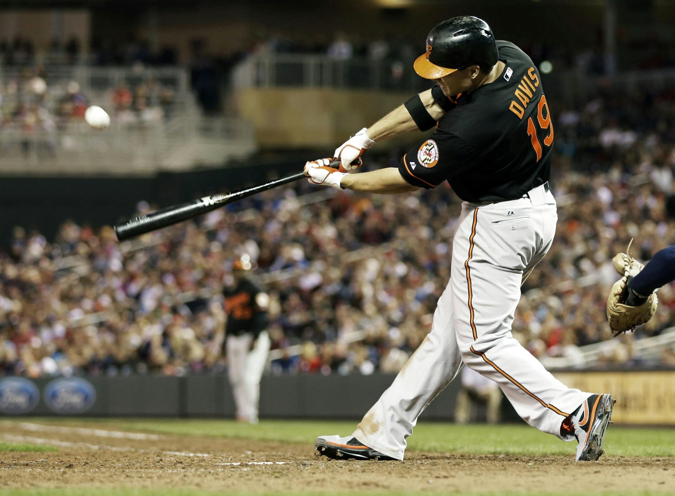 Chris Davis connects with an RBI-double to tie the game off a pitch from Minnesota Twins' Josh Roenicke in the seventh inning