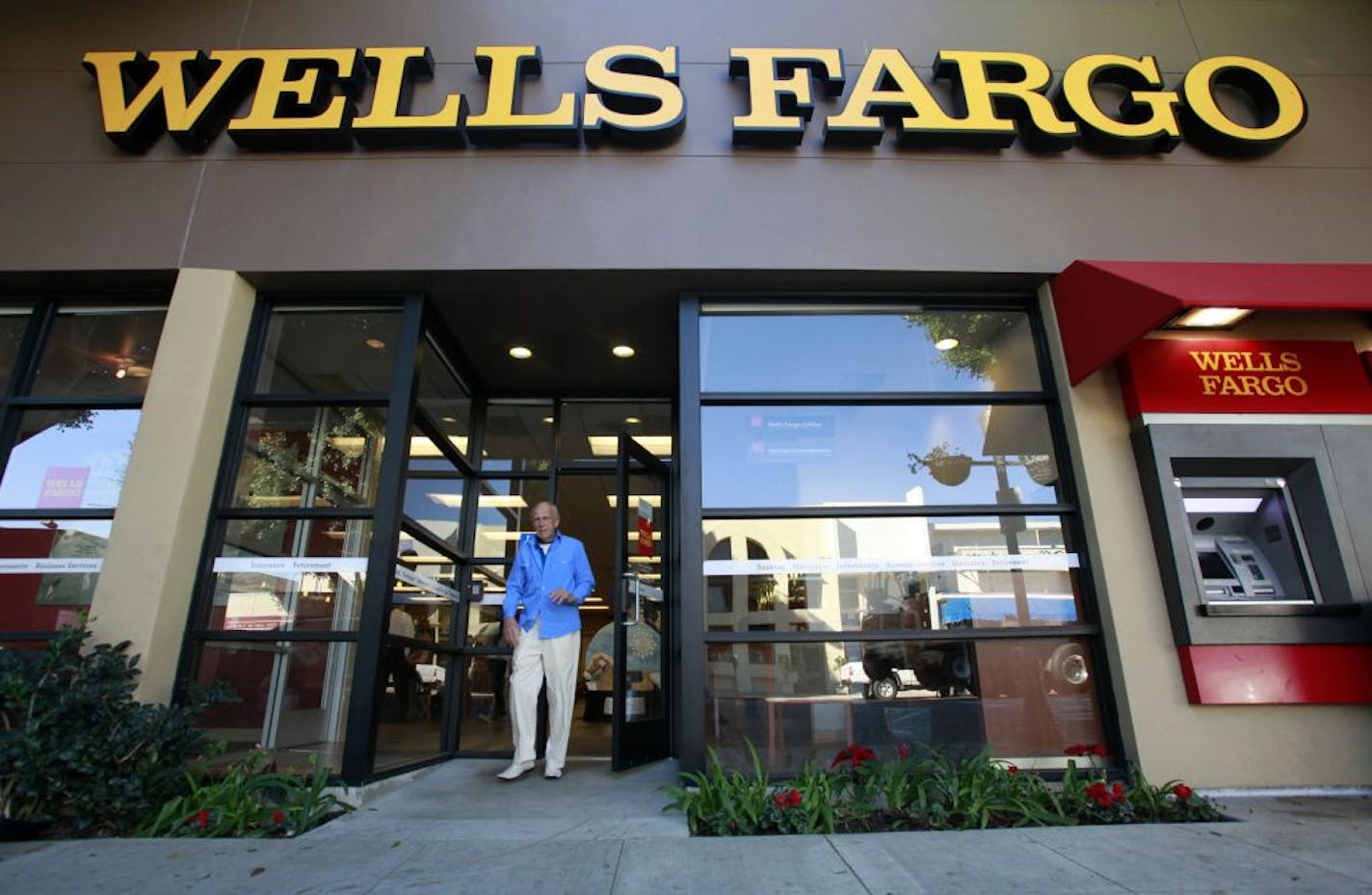 FILE - In this Jan. 18, 2011 file photo, a customer exits a Wells Fargo bank branch in Los Angeles. Are banks strong enough to spare some cash? The country will get the answer Thursday, March 15, 2012, when the Federal Reserve releases results of its so-called stress tests on the 19 largest U.S. financial institutions.