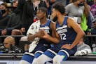 Minnesota Timberwolves center Karl-Anthony Towns (32) and Timberwolves forward Anthony Edwards (1) shake during an NBA basketball game against the Hou