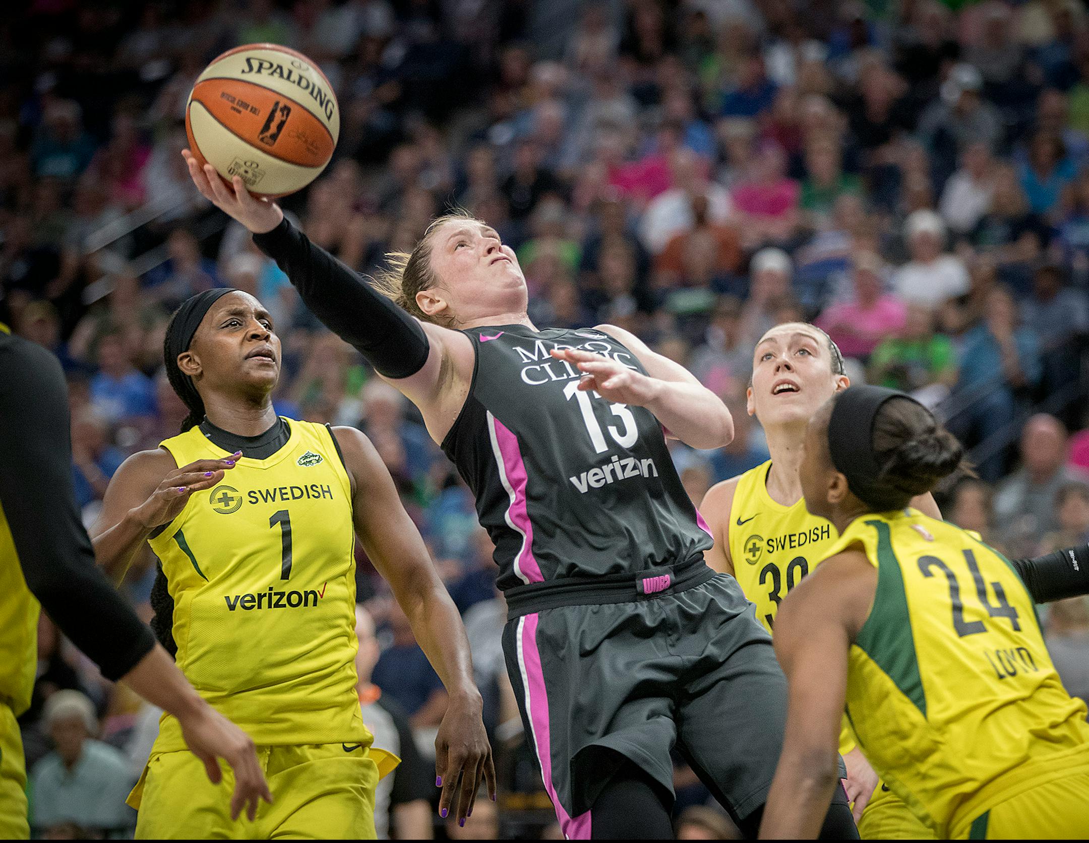 Minnesota Lynx guard Lindsay Whalen was stopped beneath the net by the Seattle Storm's Crystal Langhorne, left, forward Breanna Stewart, center, and guard Jewell Loyd during the fourth quarter.