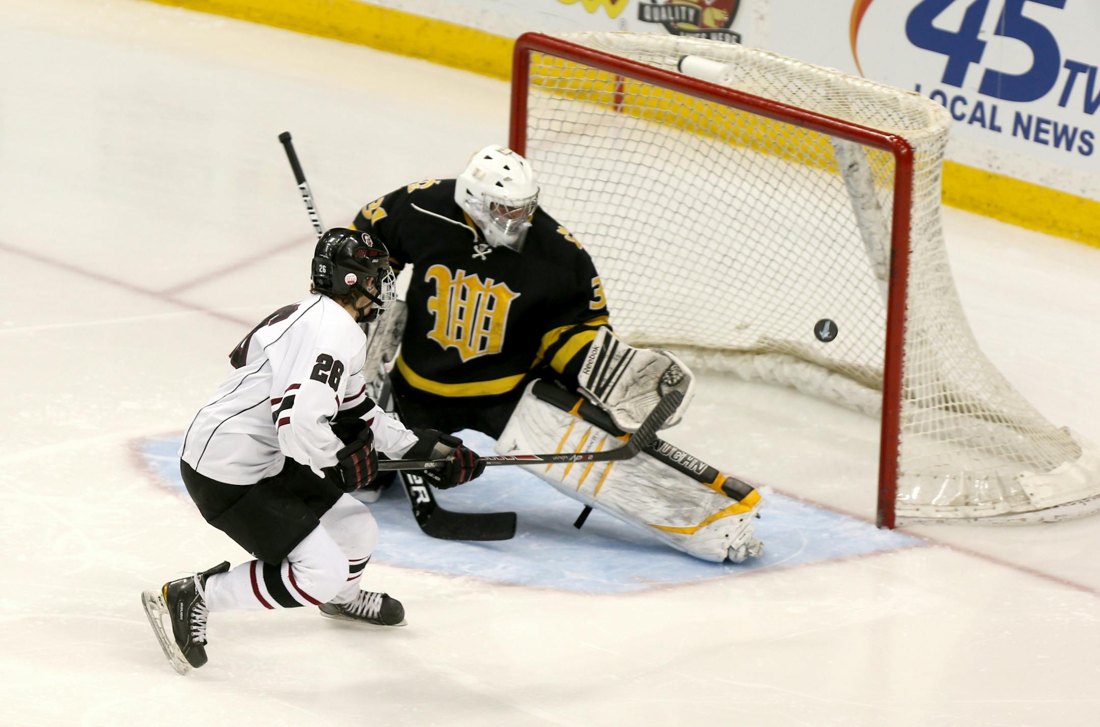 New Prague's Austin Isaacson (26) scores on Chisago Lakes Jacob Dubose (31) after he stole the puck in the neutral zone for a breakaway in the second period.