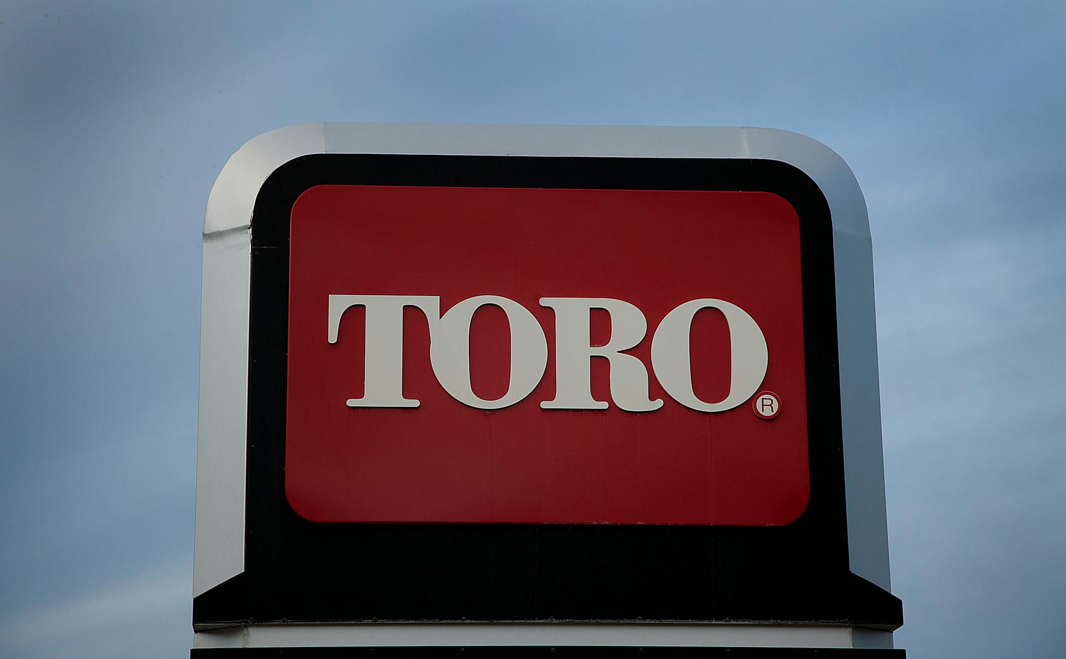 Toro Co. signage stands at the company's headquarters in Bloomington, Minnesota, U.S., on Wednesday, Dec. 28, 2011. The economy in the Minneapolis area grew moderately in 2011, with strong growth in the agriculture, energy, and mining sectors and modest growth in consumer spending, tourism, residential and commercial construction, according to a report by the Federal Reserve Board. Photographer: Ariana Lindquist/Bloomberg